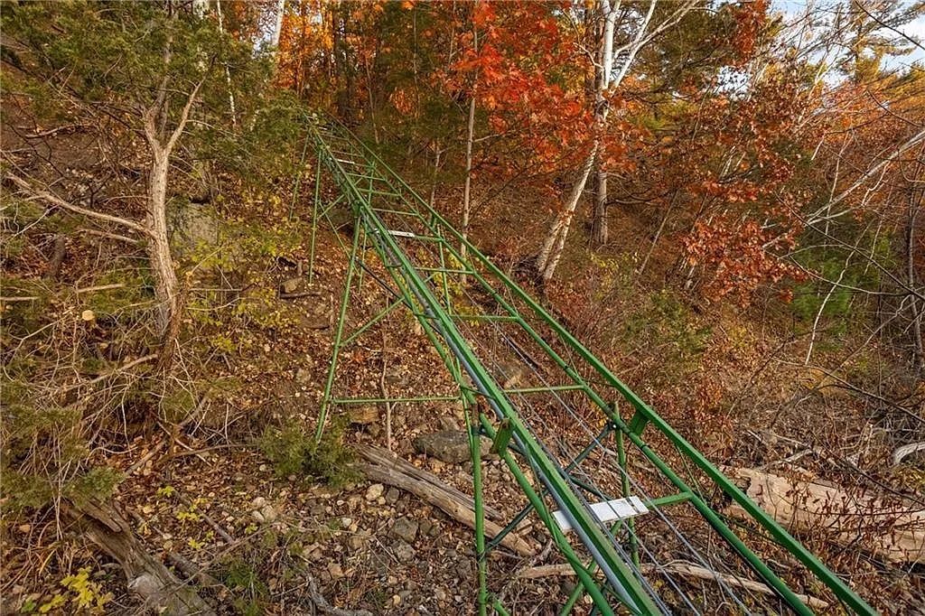 A green metal track leading down a hill. 