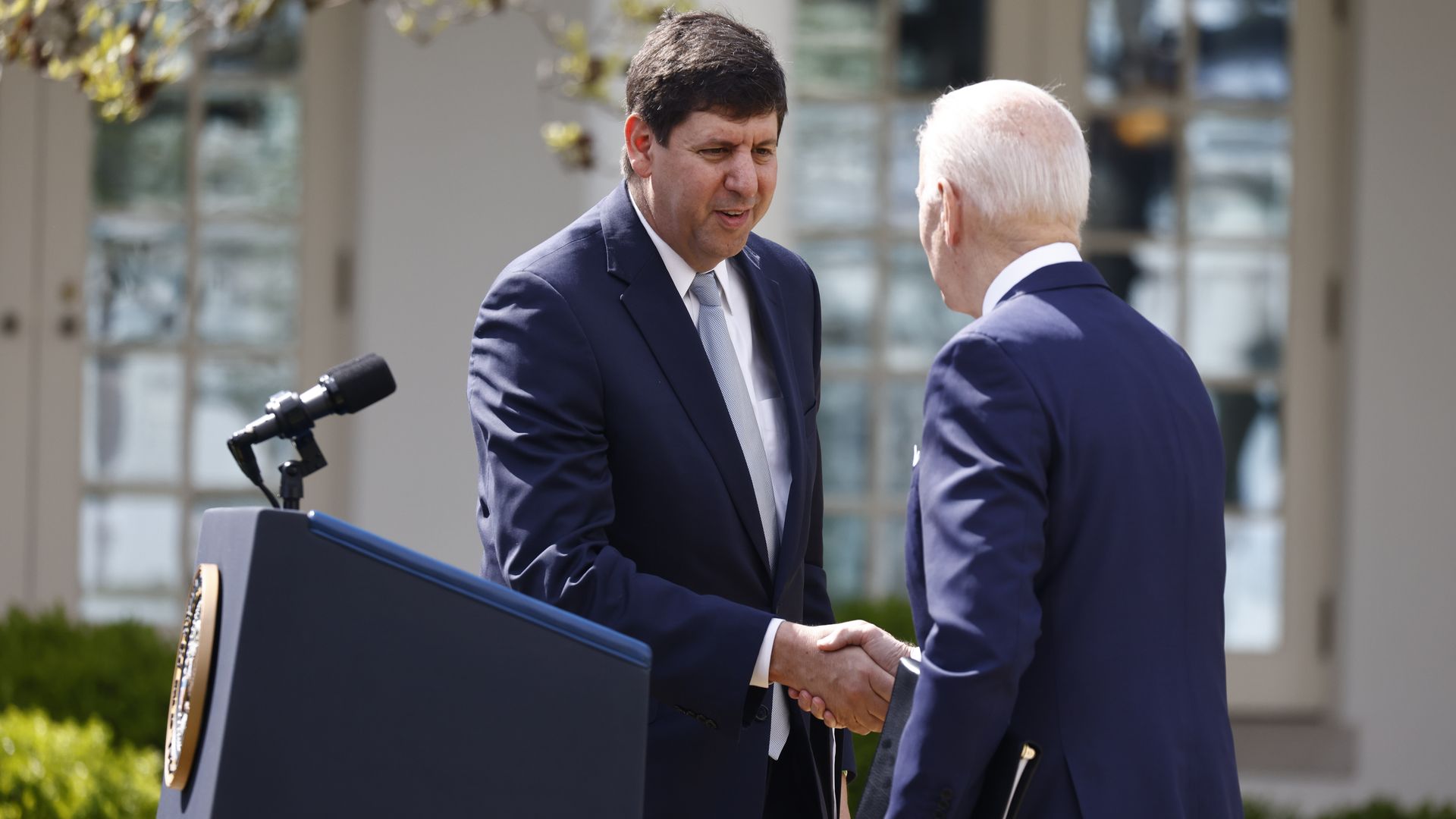 ATF nominee Steve Dettlebach is seen shaking President Biden's hand in the Rose Garden.