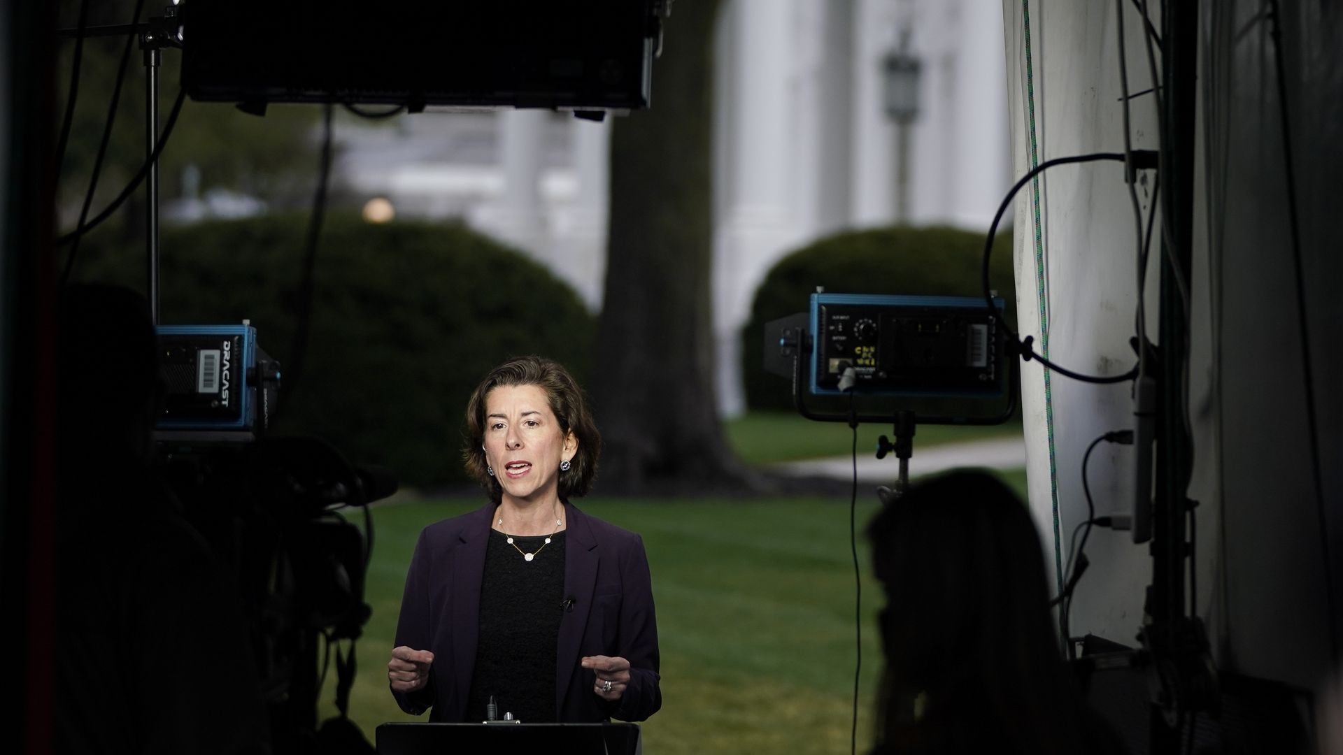 Commerce Secretary Gina Raimondo is seen giving a television interview from the White House lawn.