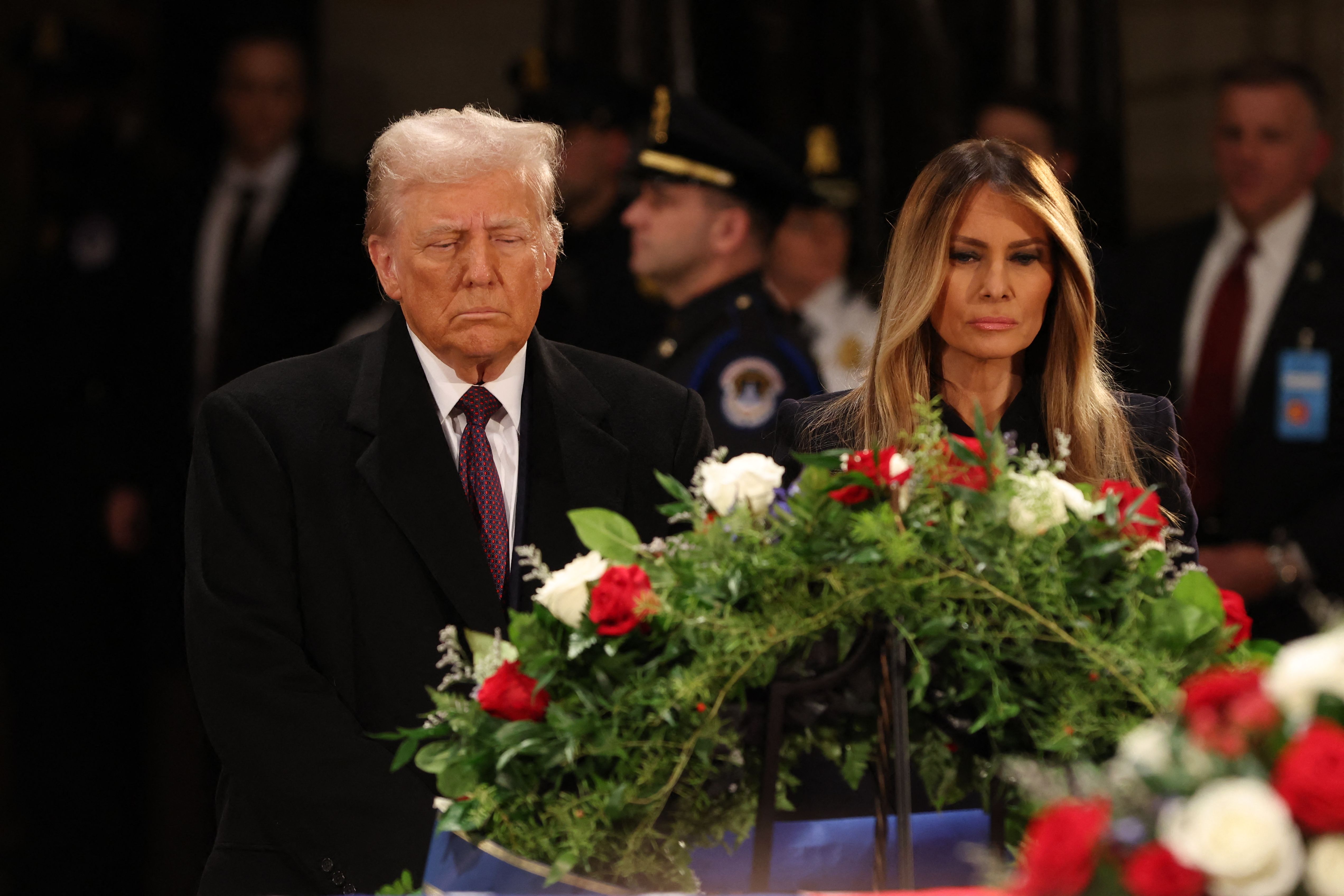 President-elect Donald Trump and former US First Lady Melania Trump pay their respects in front of the flag-draped casket of former President Jimmy Carter at the US Capitol Rotunda in Washington, DC, on January 8, 2025. Carter, the 39th President of the United States, died at the age of 100 on Decem