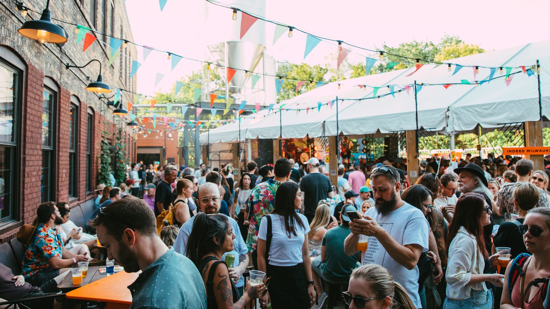 A large group of people at a music festival on a patio.