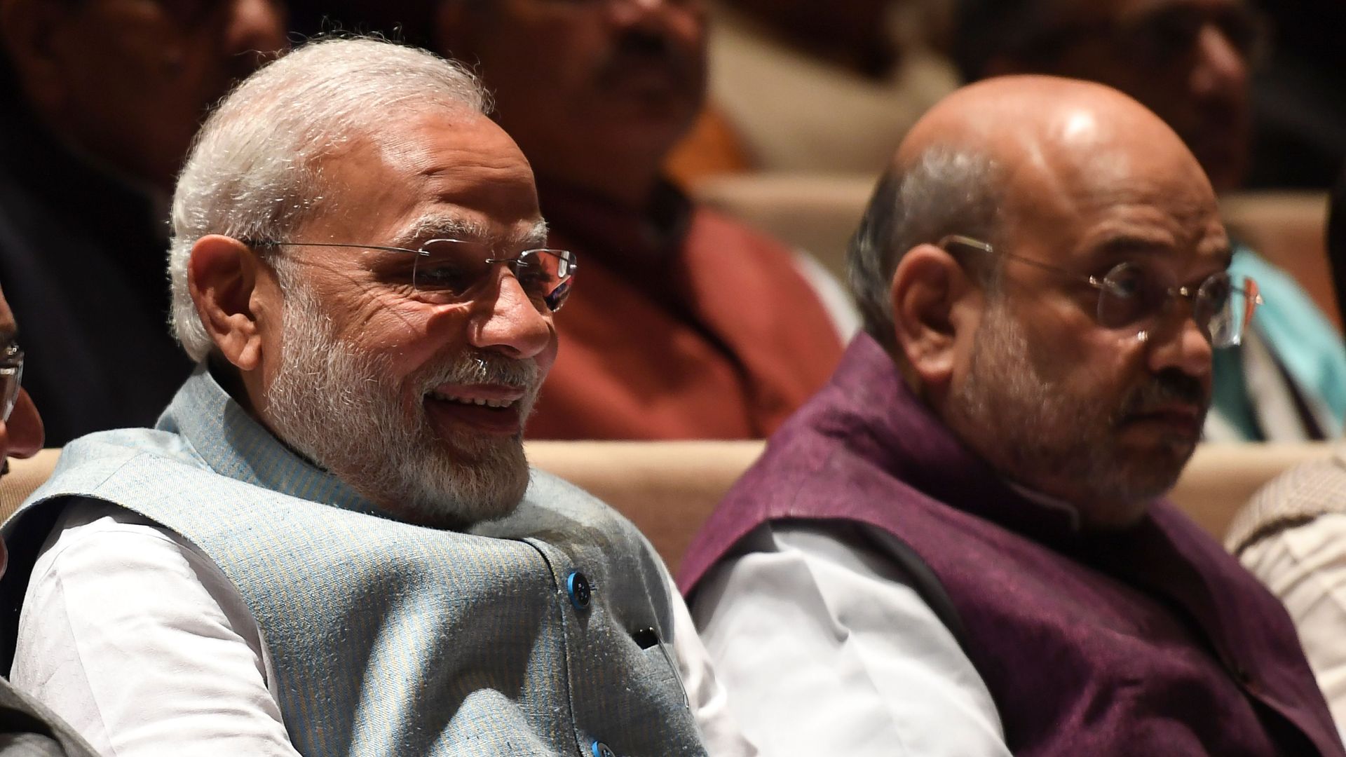 India's Prime Minister and Minister of Home Affairs sit next to each other