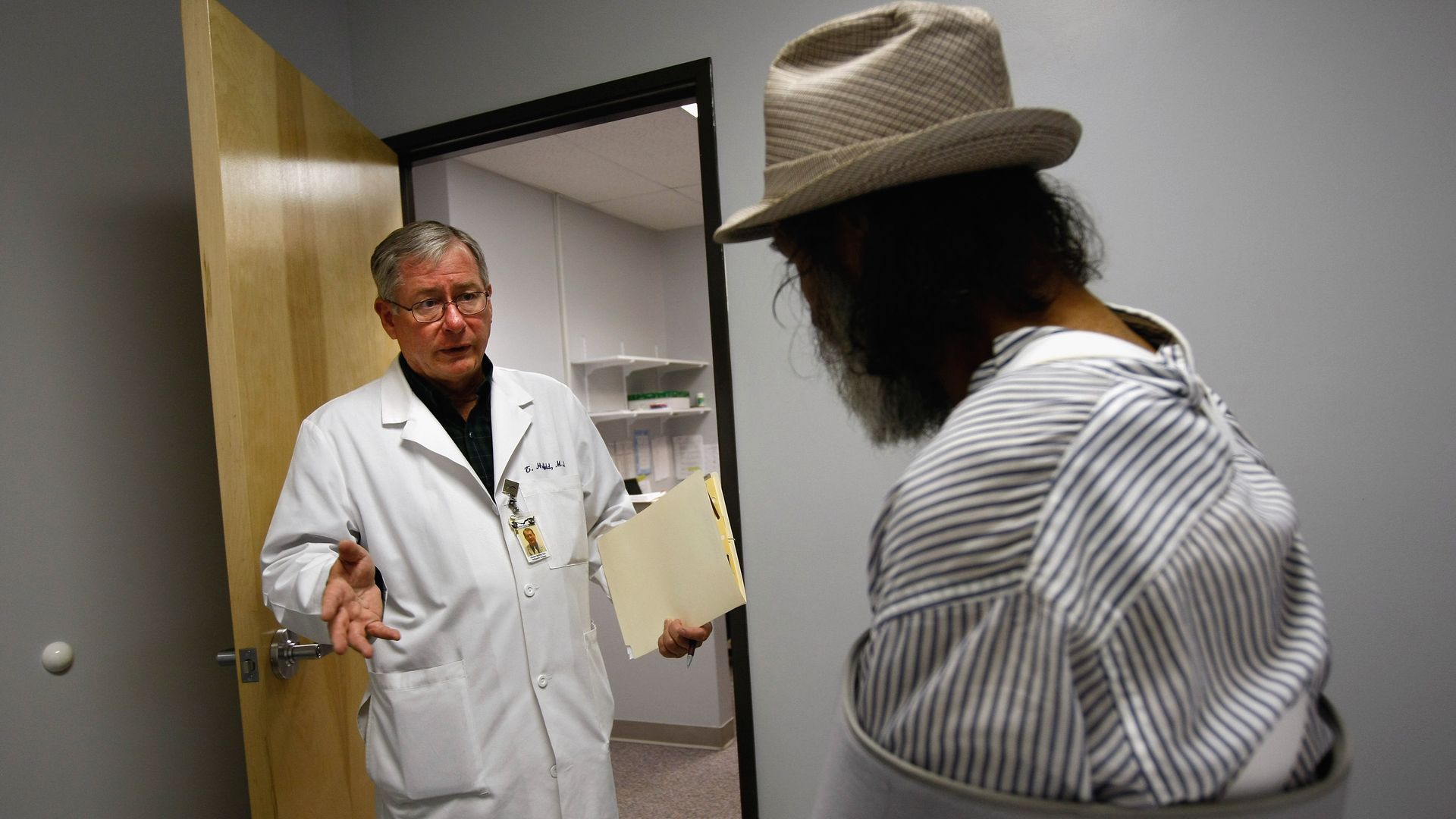 A doctor speaks with a Medicaid patient in a clinic.