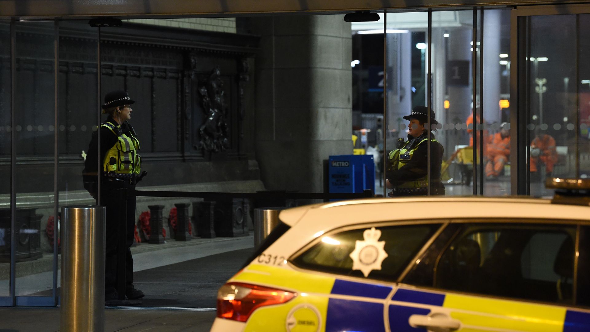 British police officers stand near a cordon at Manchester Victoria Station, in Manchester on January 1, 2019, following a stabbing on New Year's Eve. 