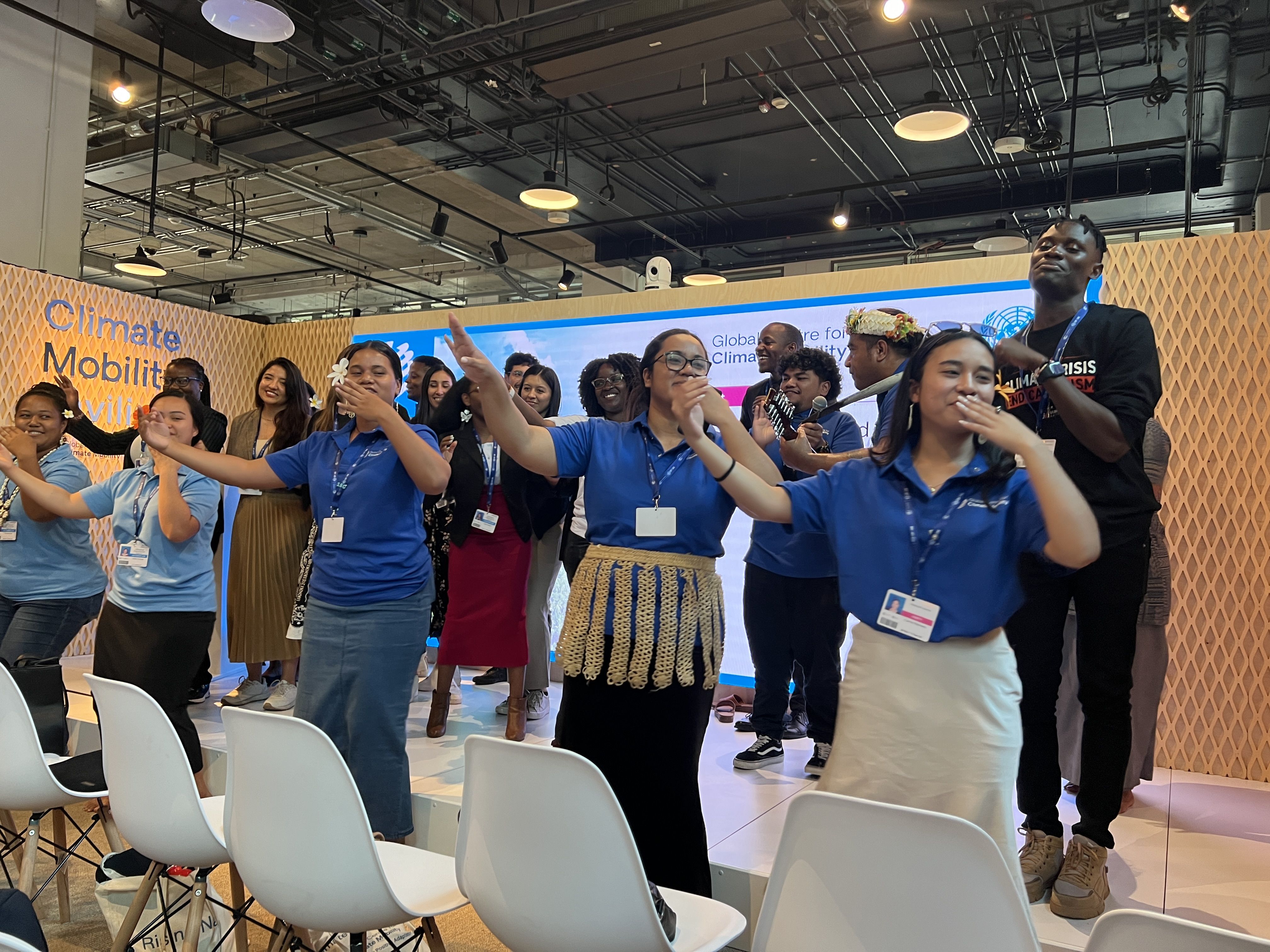 Pacific island youth share traditional music and dance at the Climate Mobility Pavilion in the Blue Zone at COP28 on Dec. 8. Photo: Laurin-Whitney Gottbrath