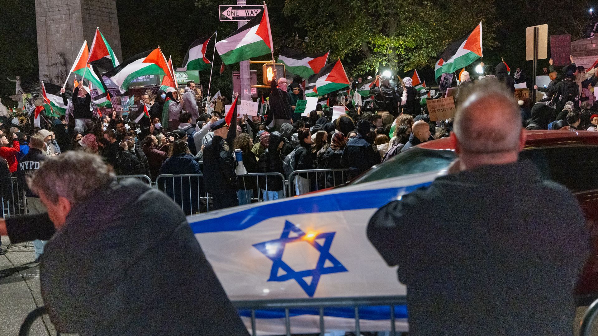 People holding Israeli and Palestinian flags during protests in New York City on Nov. 11.