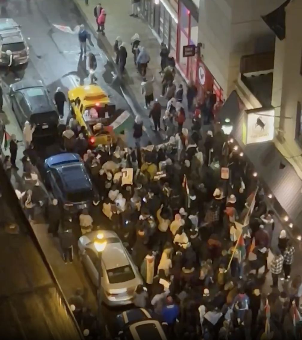 Protesters in Philadelphia stand outside of Goldie, a falafel restaurant.