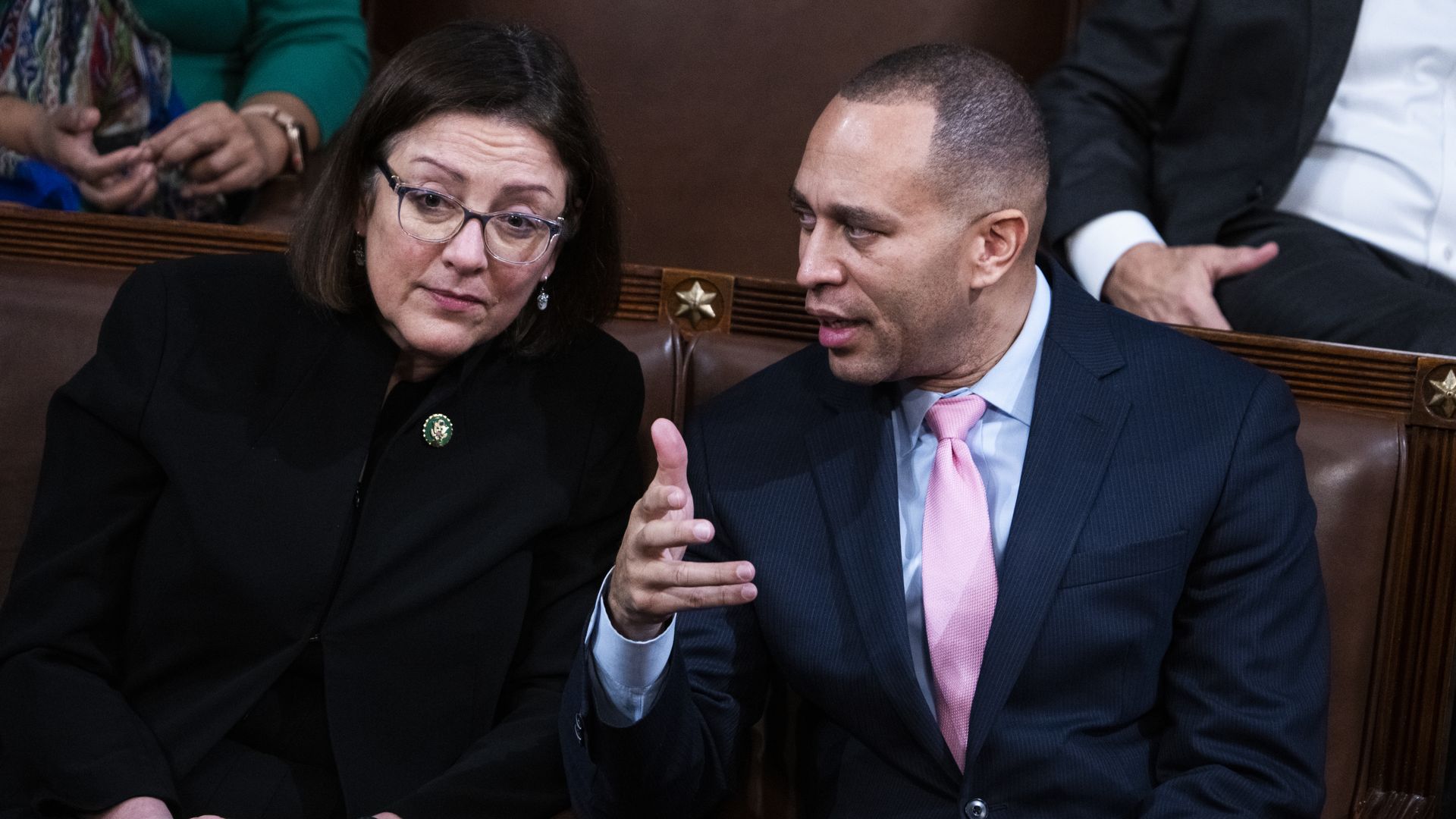 Reps. Suzan DelBene and Hakeem Jeffries, talking and sitting in brown leather chairs.
