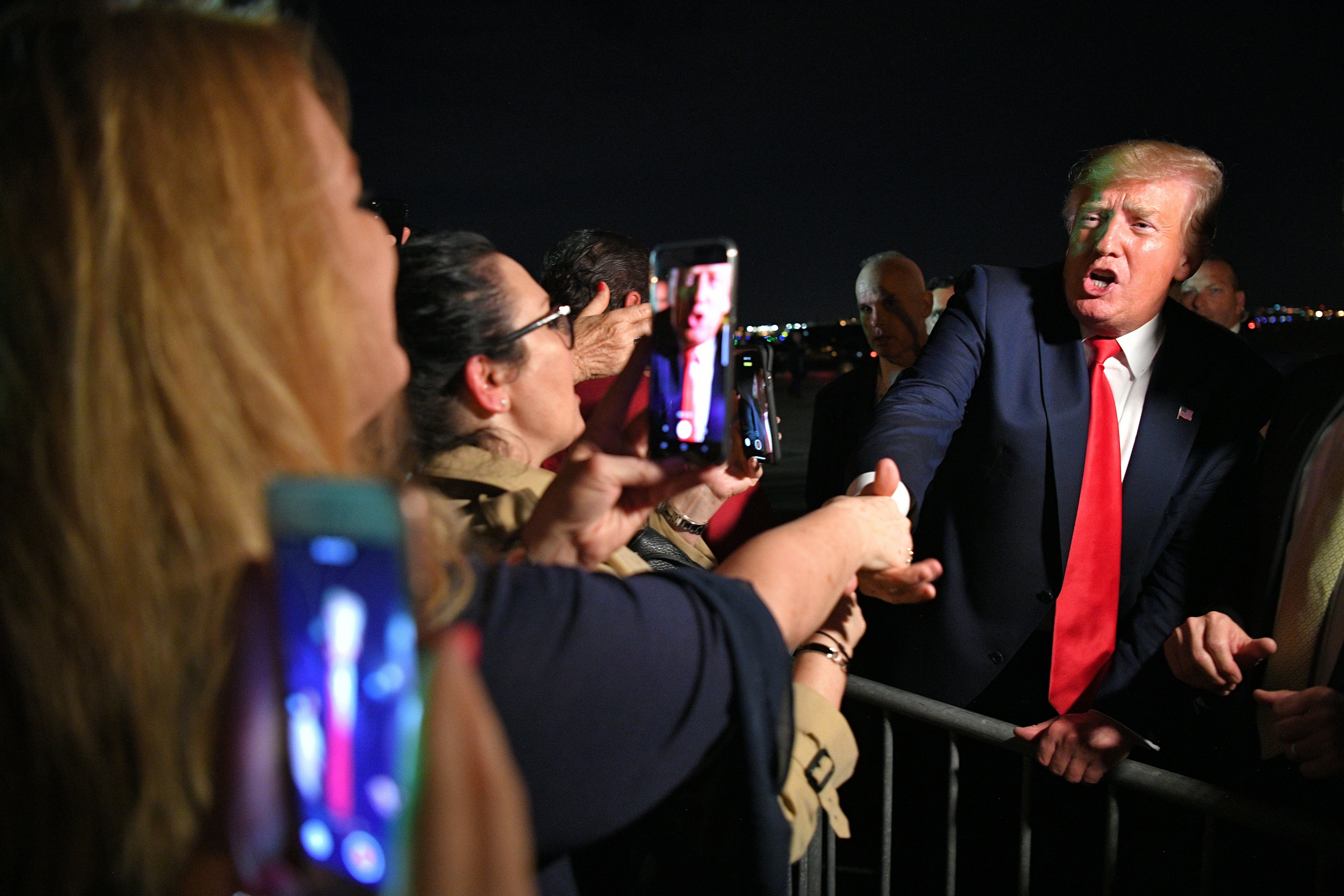 Trump meets fans after stepping off Air Force One upon arrival at Miami International Airport in Miami, Florida on June 18, 2019. 