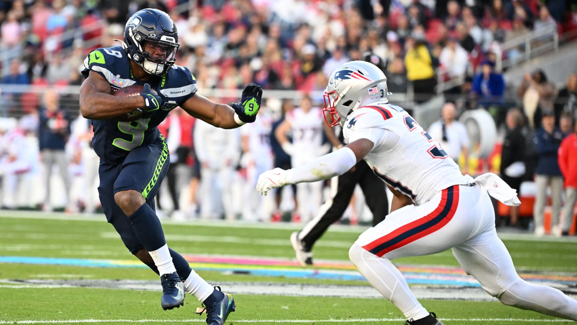 New England Patriots'  Craig Woodson rushes Seattle Seahawks' Kenneth Walker III during Super Bowl LX at Levi's Stadium in Santa Clara, Calif. 