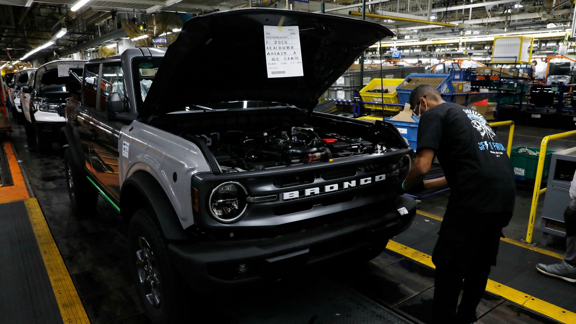 A line worker assembles Ford Motor Company's 2021 Ford Bronco on the line at their Michigan Assembly Plant in Wayne, Michigan on June 14