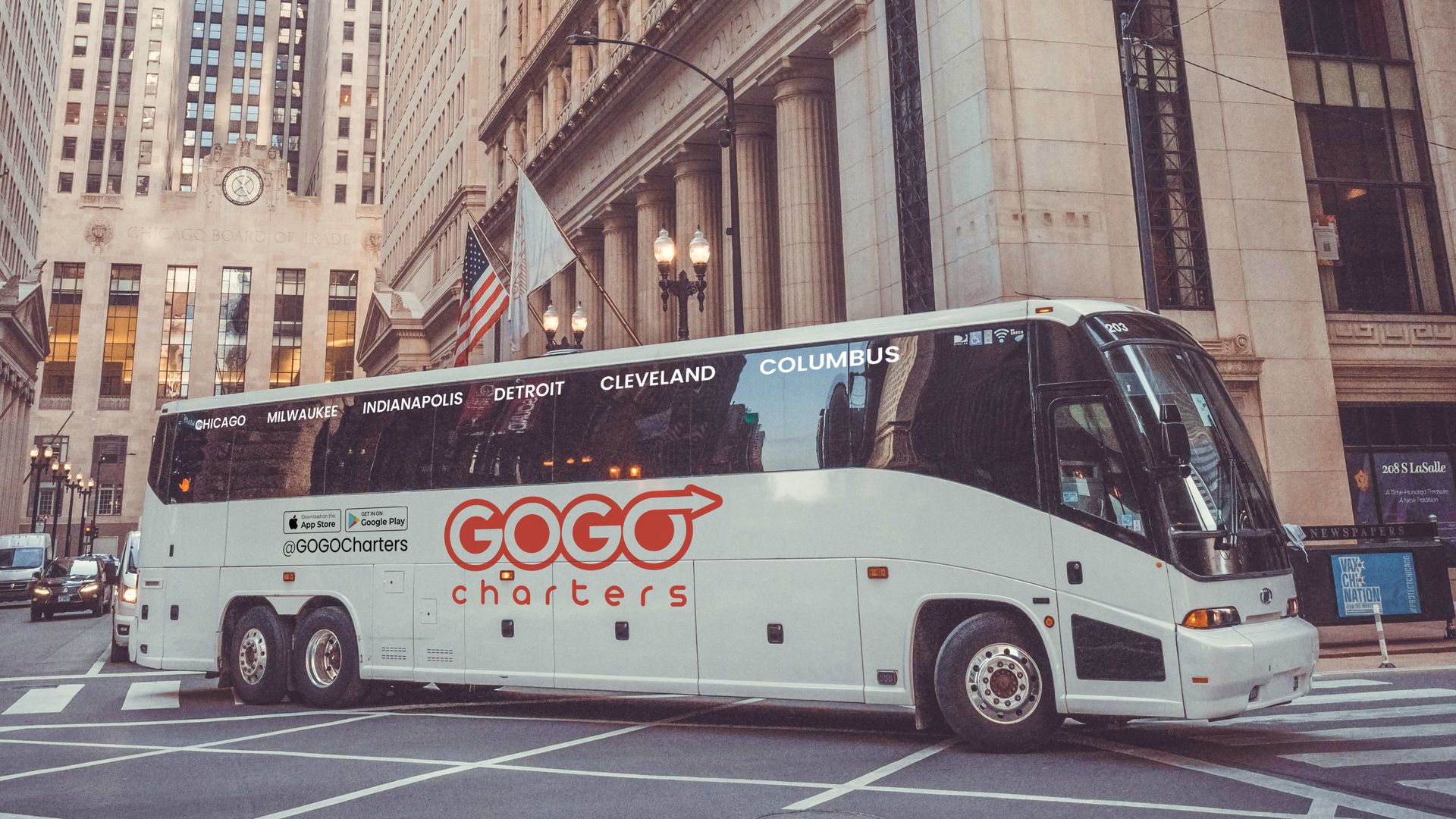 A white coach bus in a city