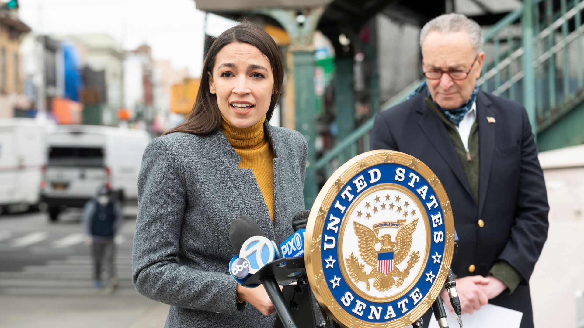 Democratic Congresswoman from New York Alexandria Ocasio-Cortez speaks as Senate Minority Leader Chuck Schumer listens during a press conference in Queens on April 14, 2020 in New York