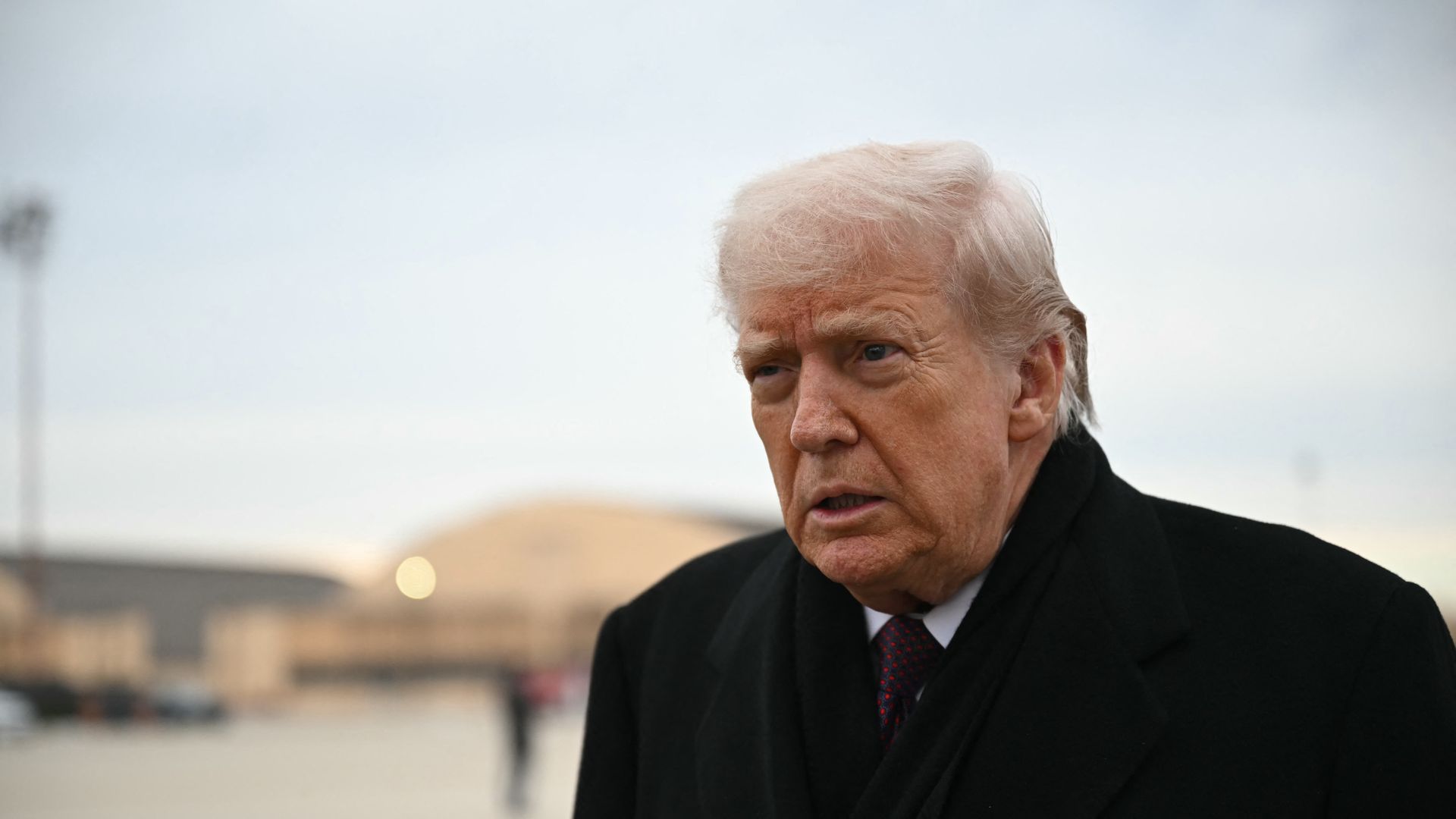 man stands in black coat