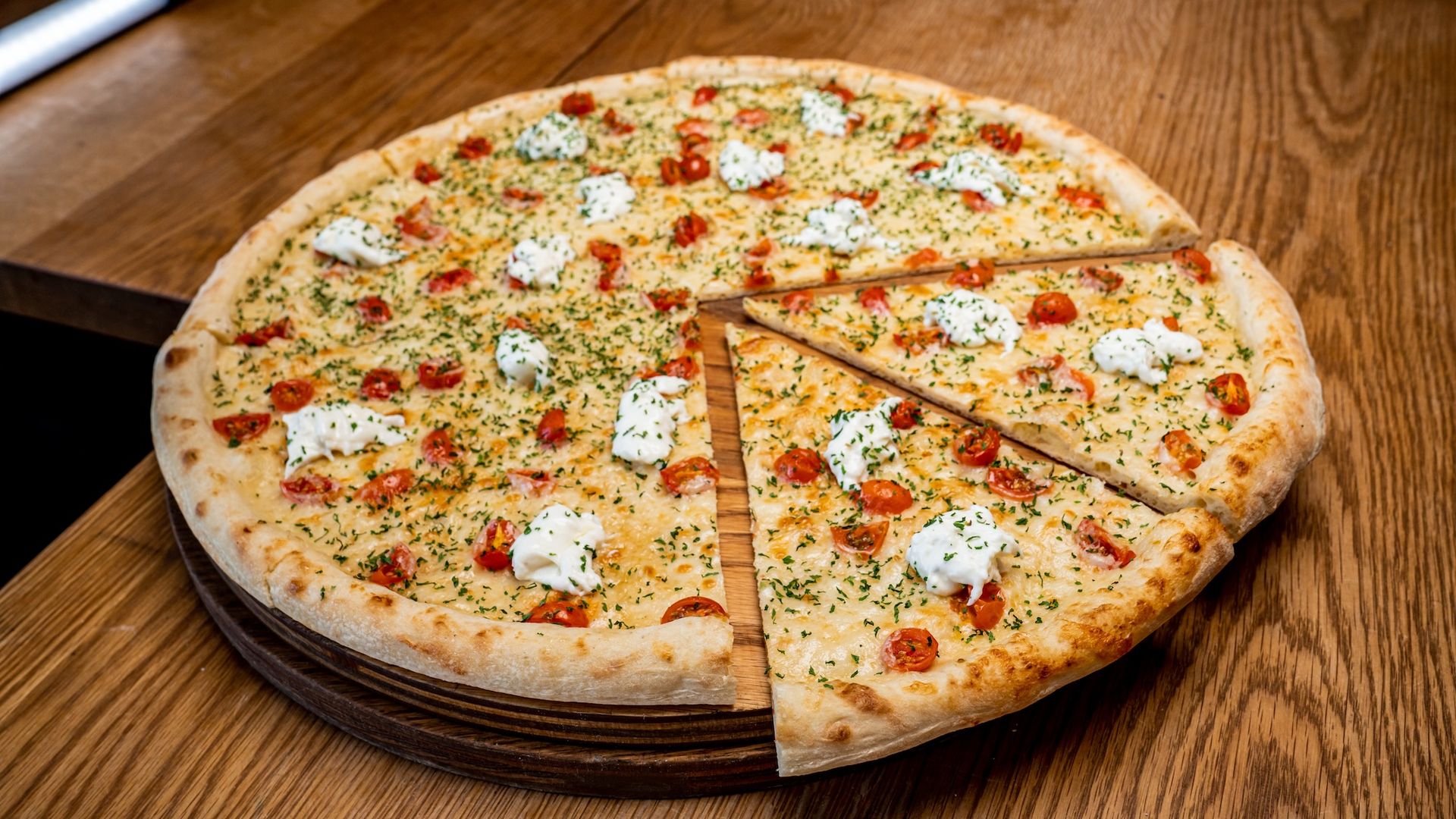 A large pizza with two slices pulled out.