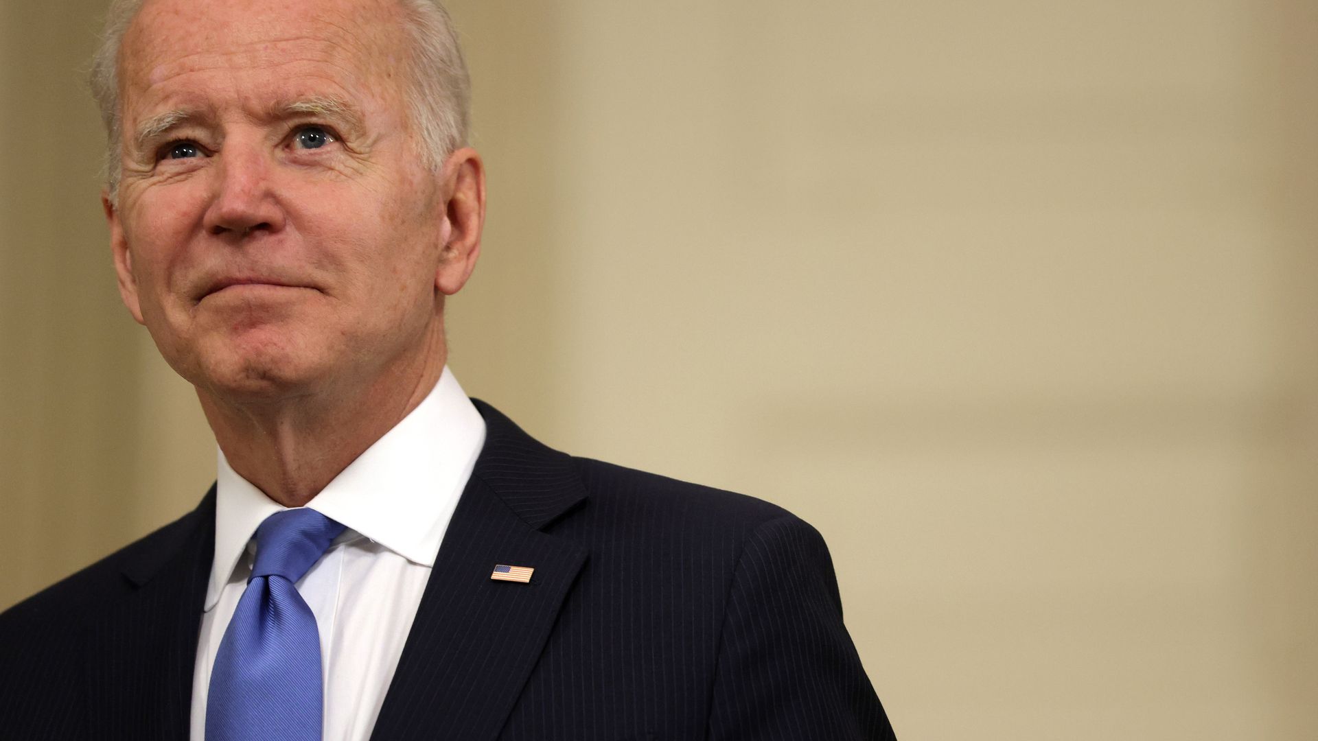 President Biden is seen smiling after delivering remarks at the White House.