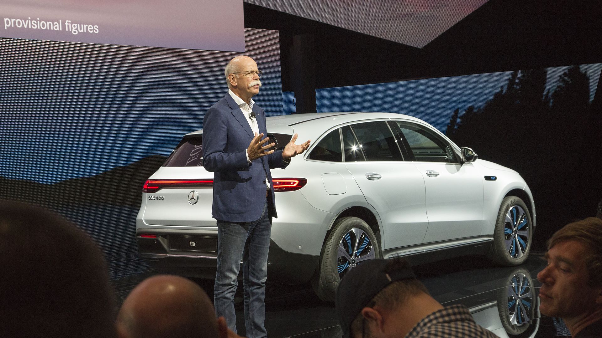 Daimler CEO speaking in front of a Mercedes