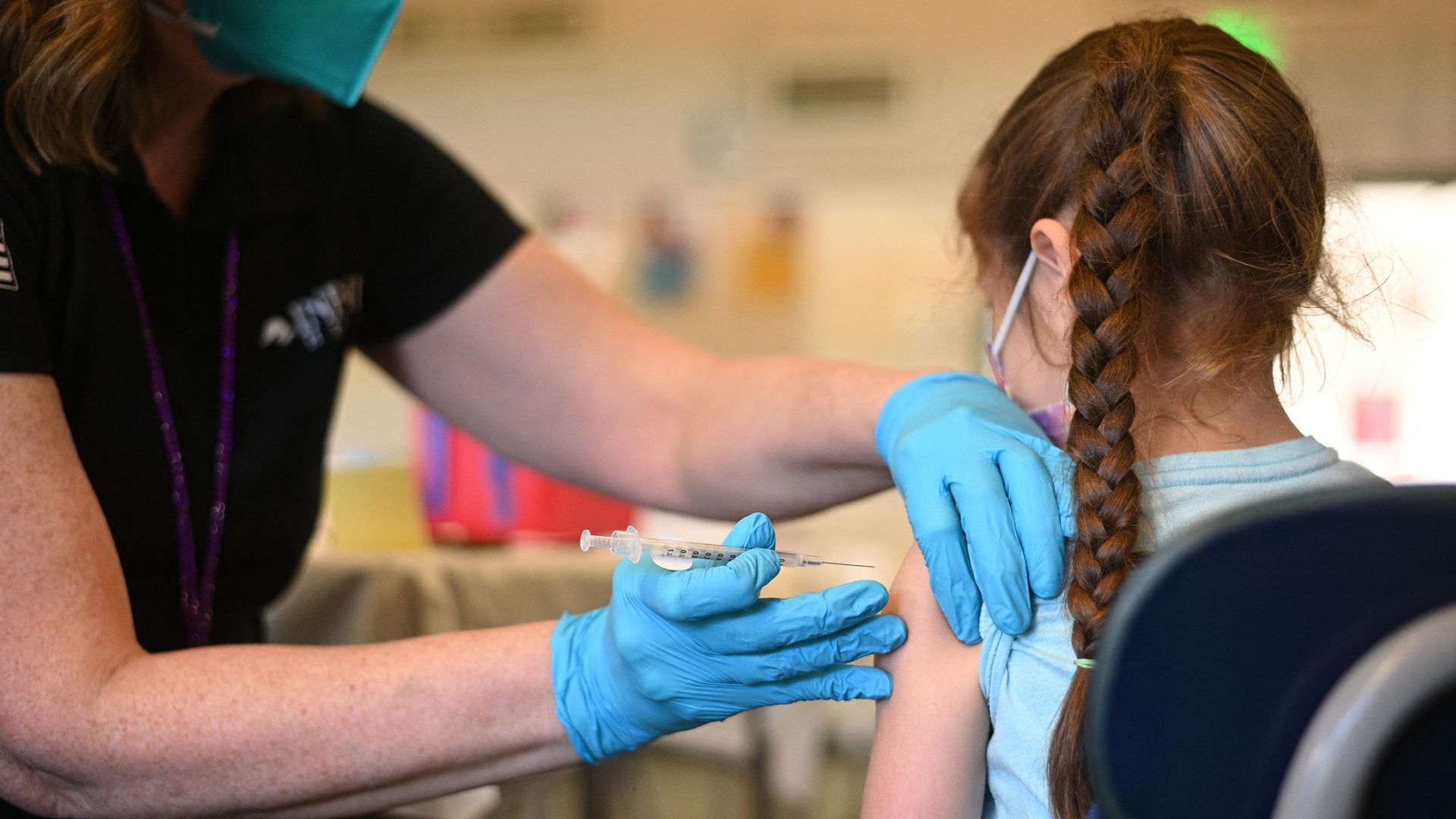 A nurse administers a pediatric dose of the Covid-19 vaccine to a girl at a L.A. Care Health Plan vaccination clinic.
