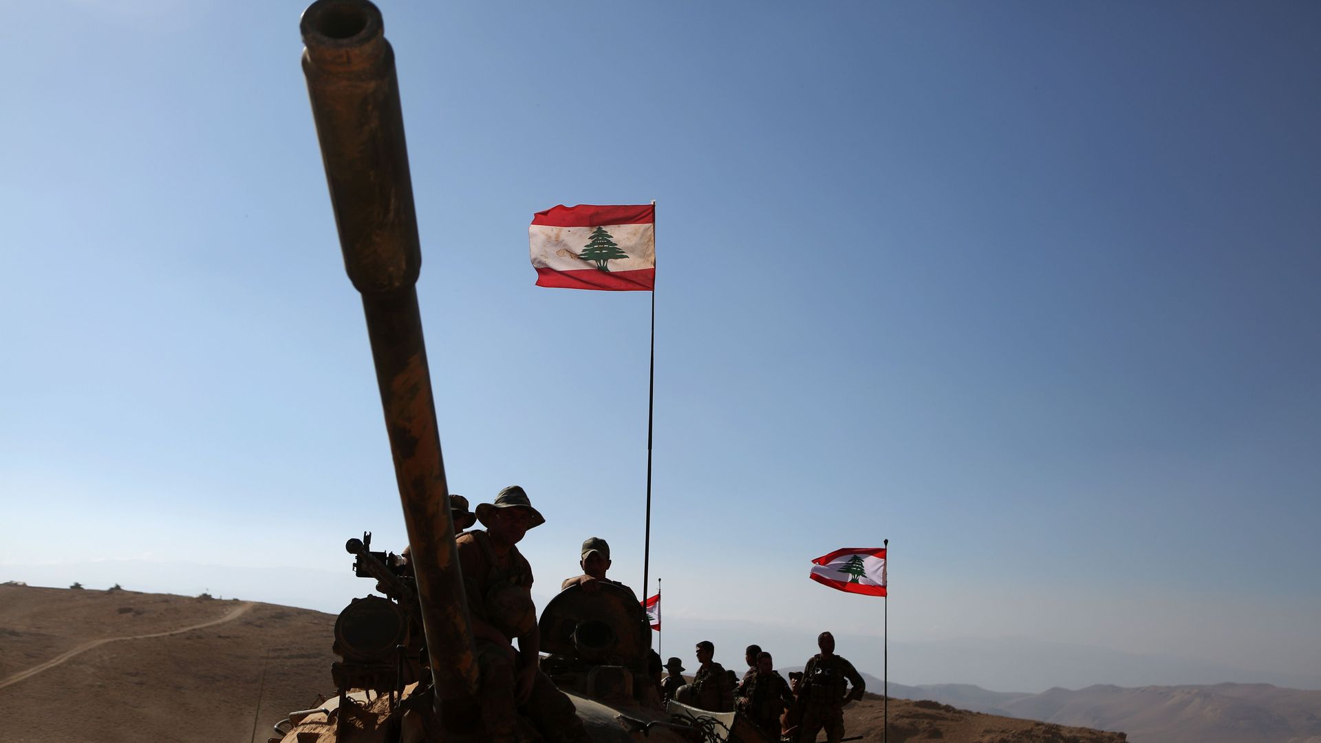 Lebanese army soldiers with the 6th Brigade standing on a tank ion the Syrian-Lebanese border on August 28, 2017.