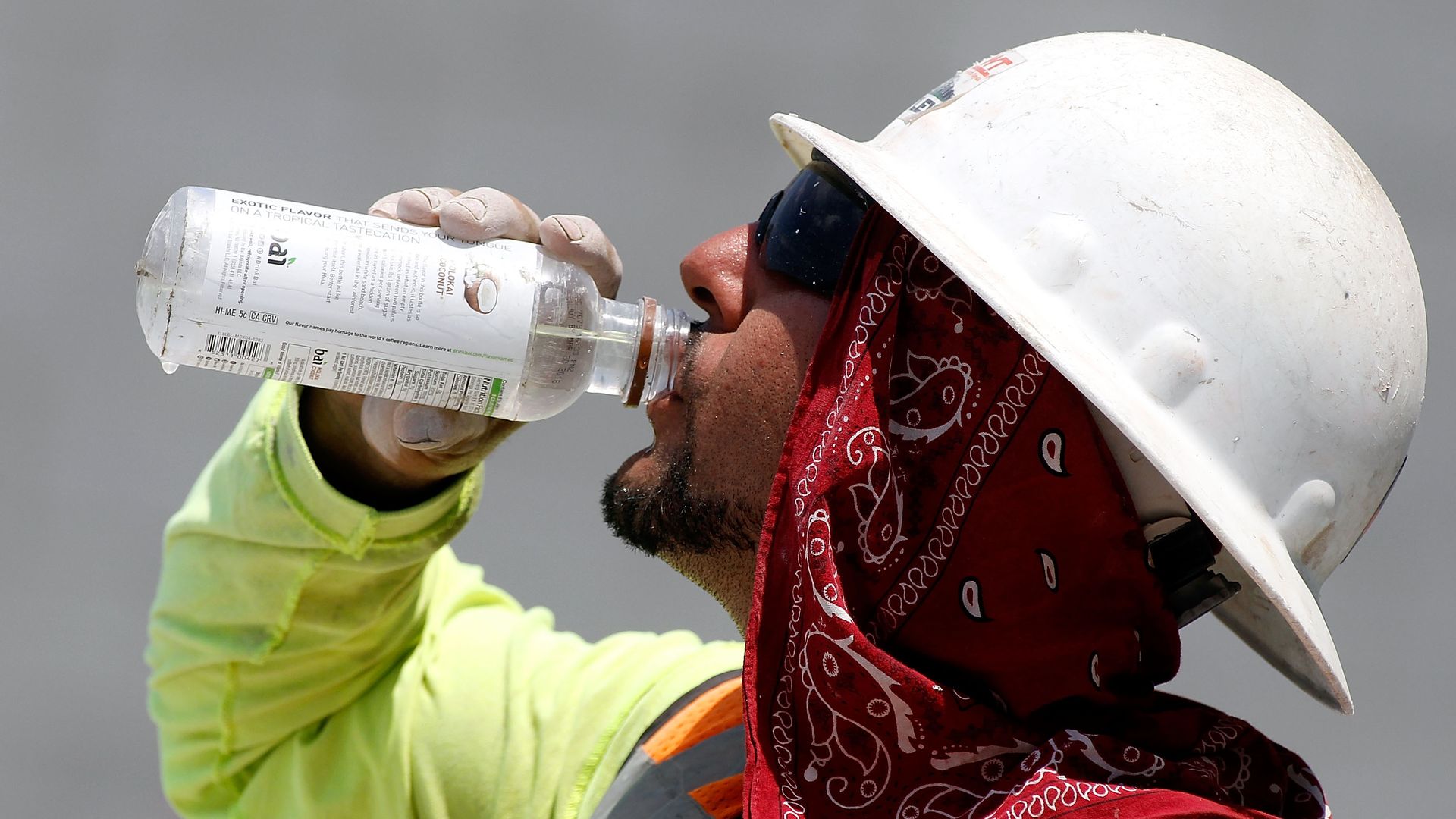A man in a construction hat and best drinking water.