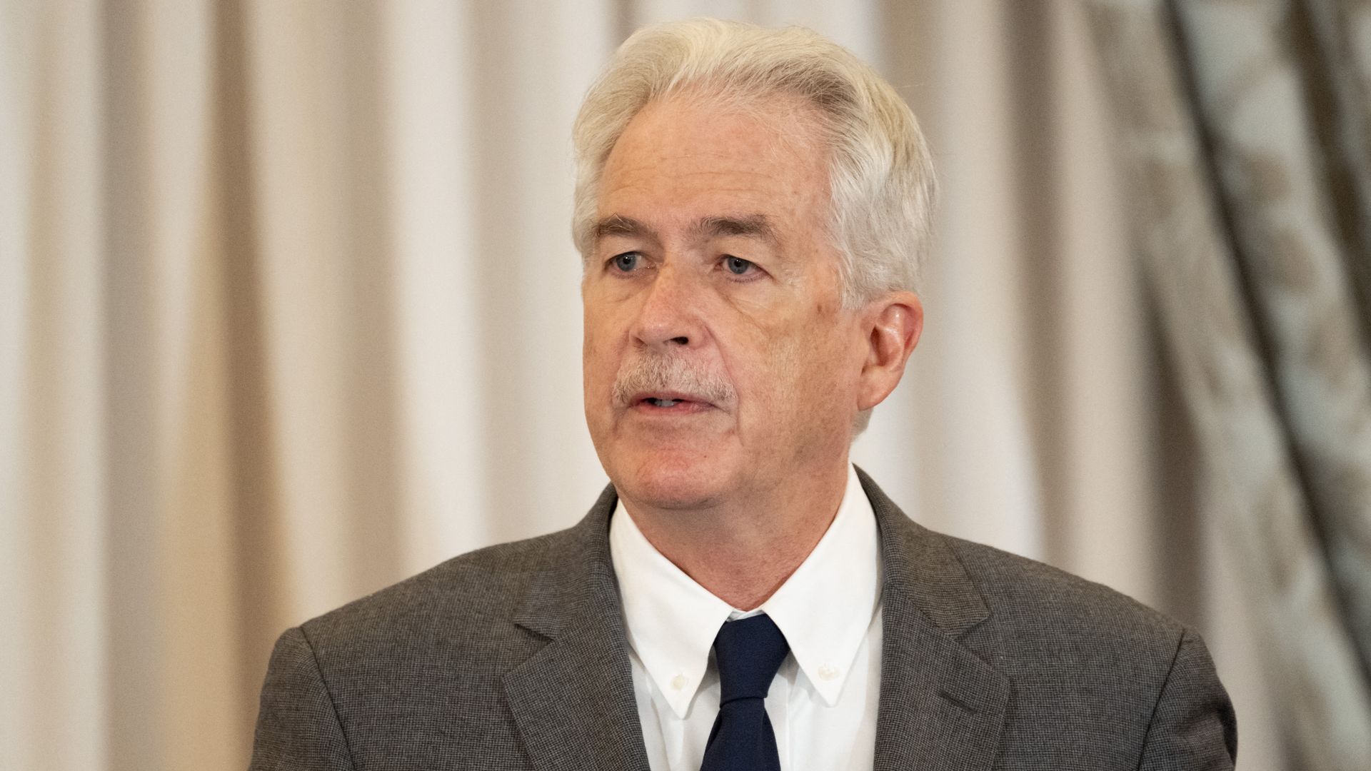 CIA director Bill Burns in a dark suit, white shirt, dark tie