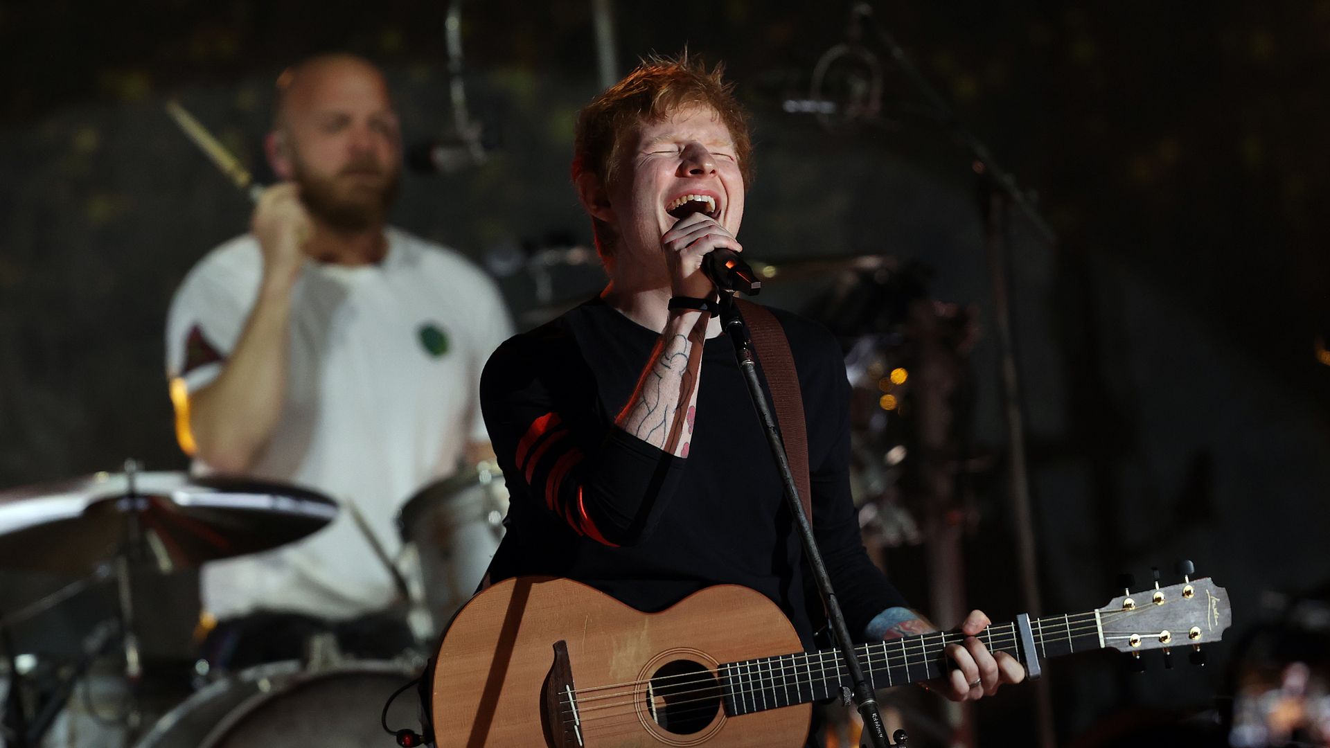 Ed Sheeran performs onstage with Coldplay at London's Shepherd's Bush Empire.