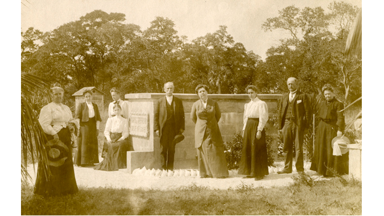 Koreshans standing by the grave of Dr. Cyrus Teed.