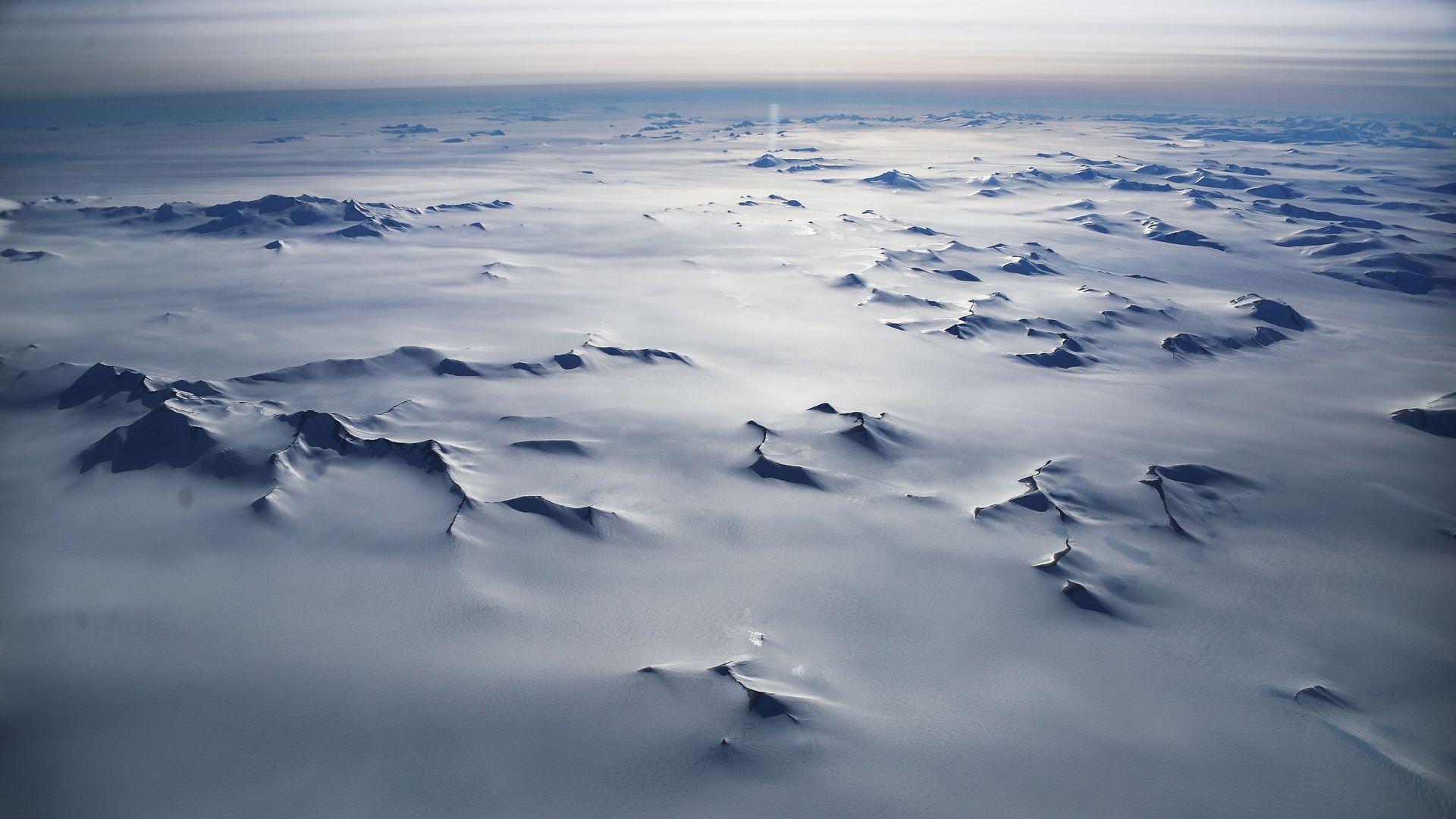 Aerial image of the Antarctic Ice Sheet, shimmering in the sun.
