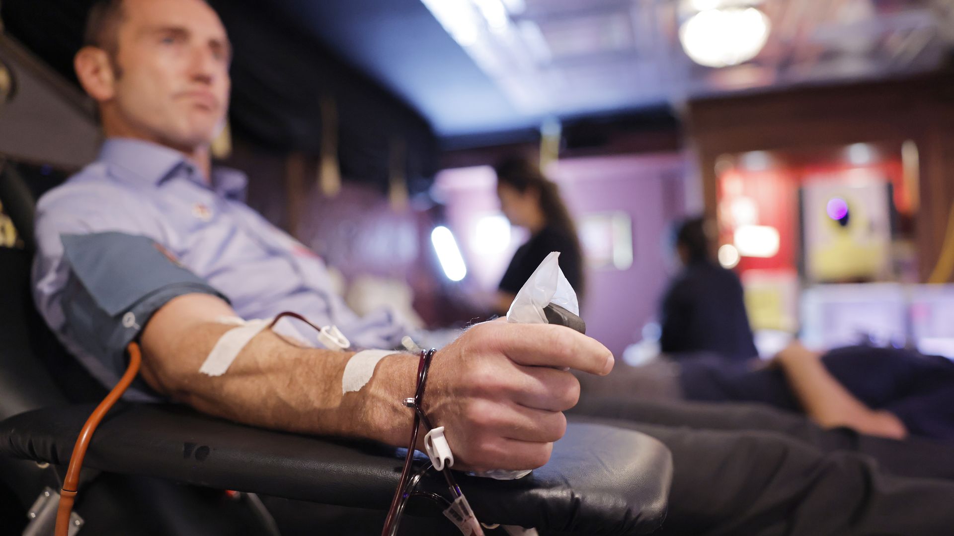 A person donates blood while lying on a cot during an American Red Cross blood drive at the Magic Castle in Los Angeles.