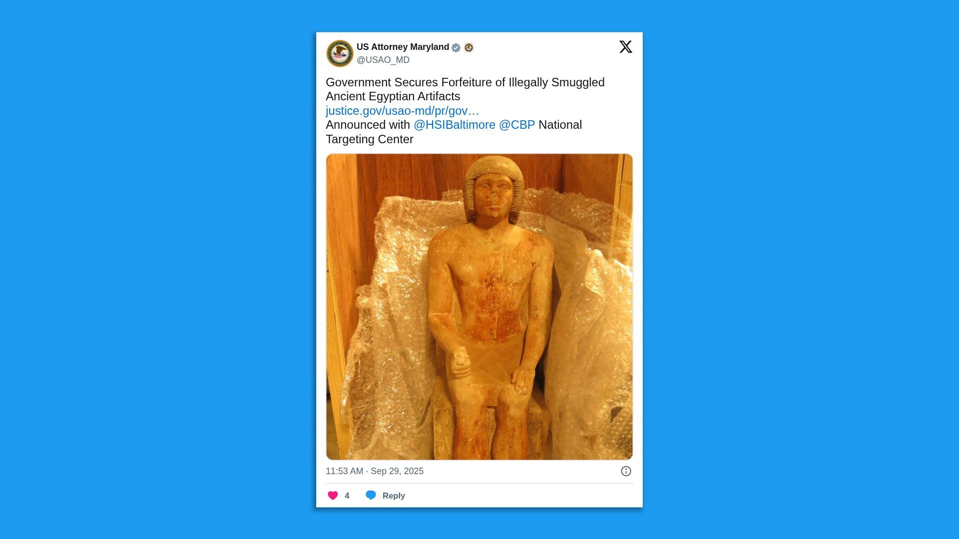 Tweet from US Attorney Maryland about seizing illegally smuggled Ancient Egyptian artifacts, showing a seated, reddish-brown Egyptian statue wrapped with bubble wrap inside a wooden crate.