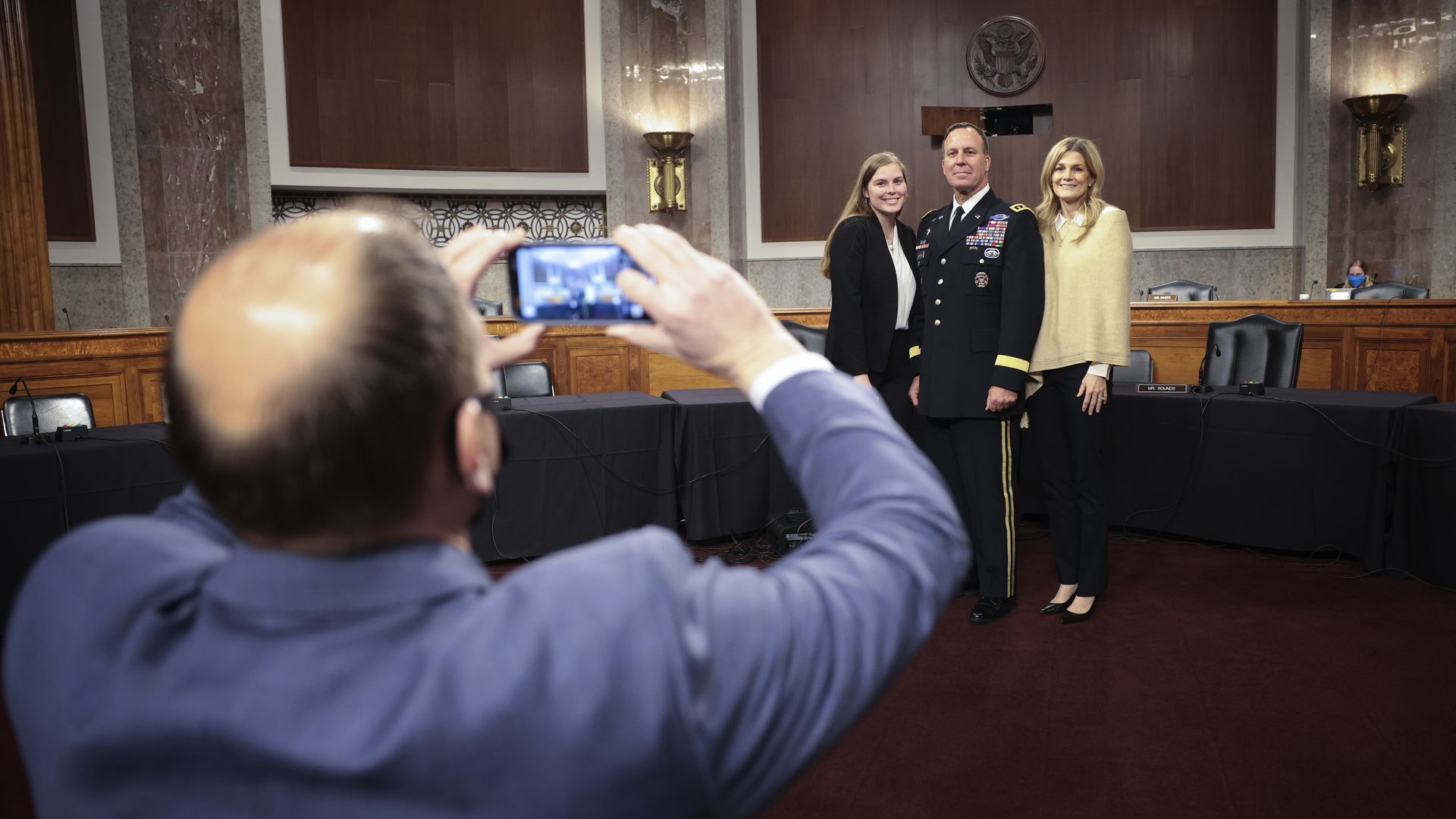 A general nominated to lead U.S. Central Command poses with his family before his confirmation hearing.