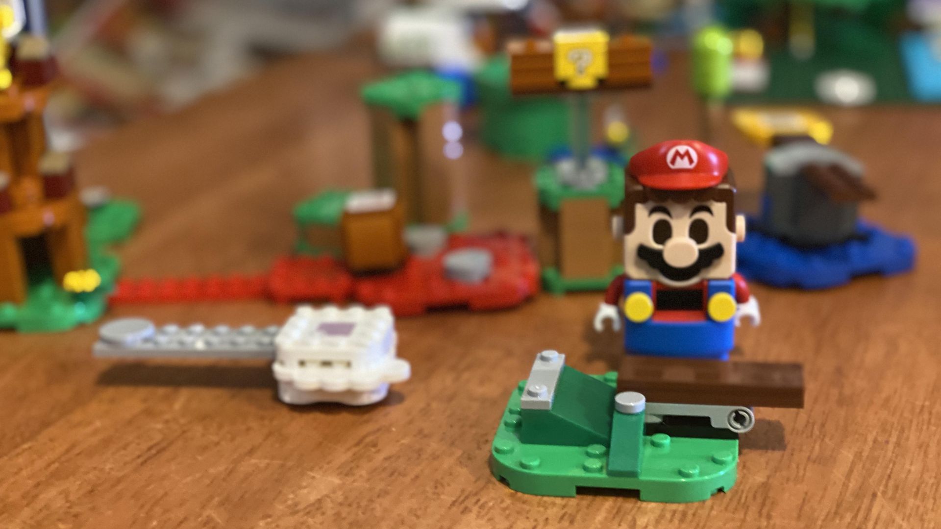 A close-up photo of the Lego Mario figure and various other pieces from the set.