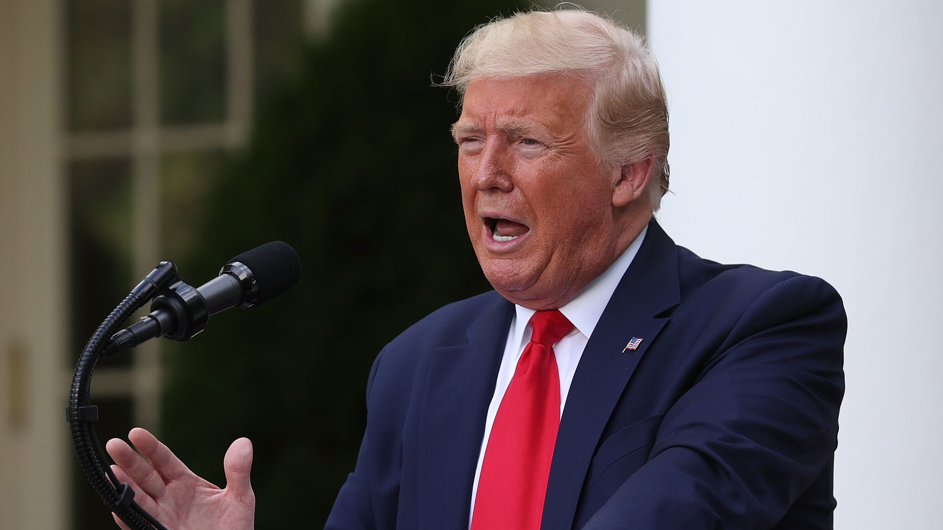 President Trump speaking at a podium in the Rose Garden