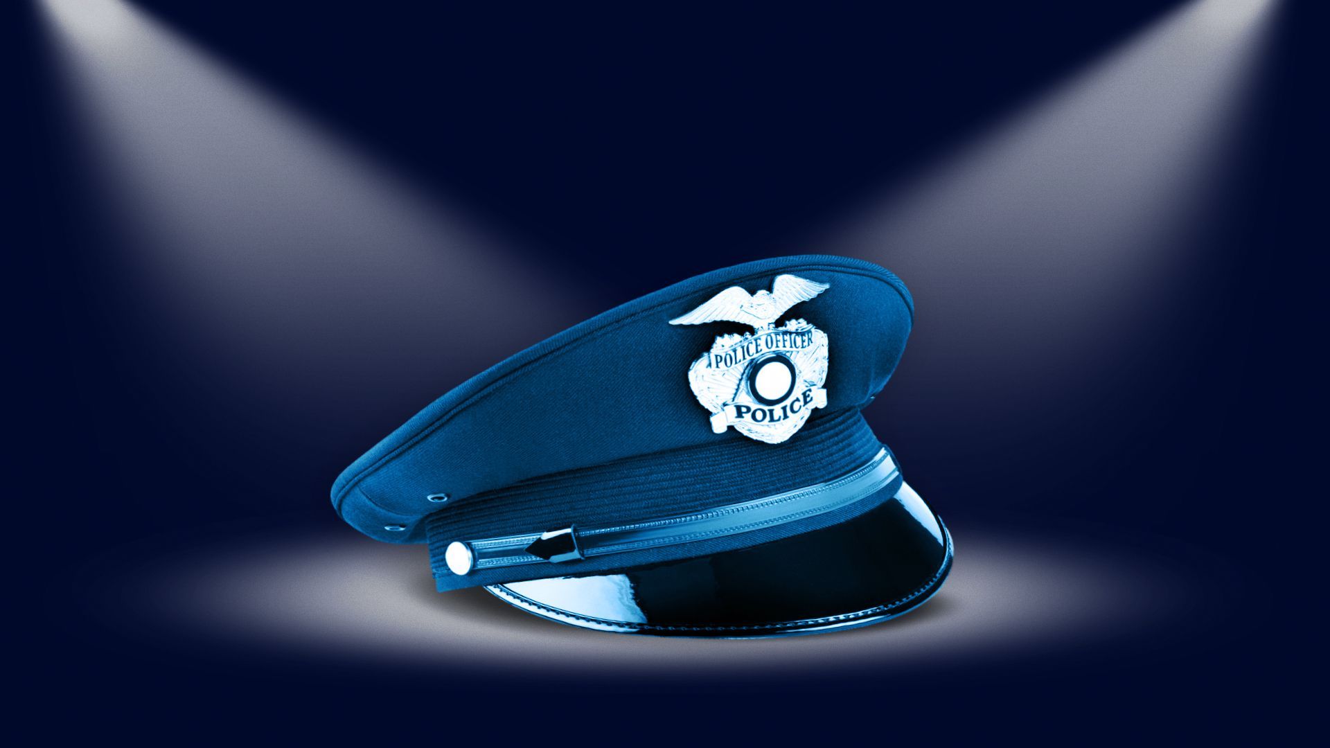 Illustration of a police cap on dark background under spotlights.