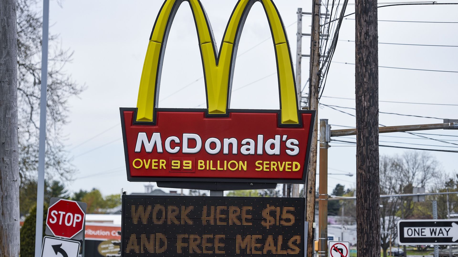 A McDonald's sign that reads " Work here $15 and free meals"