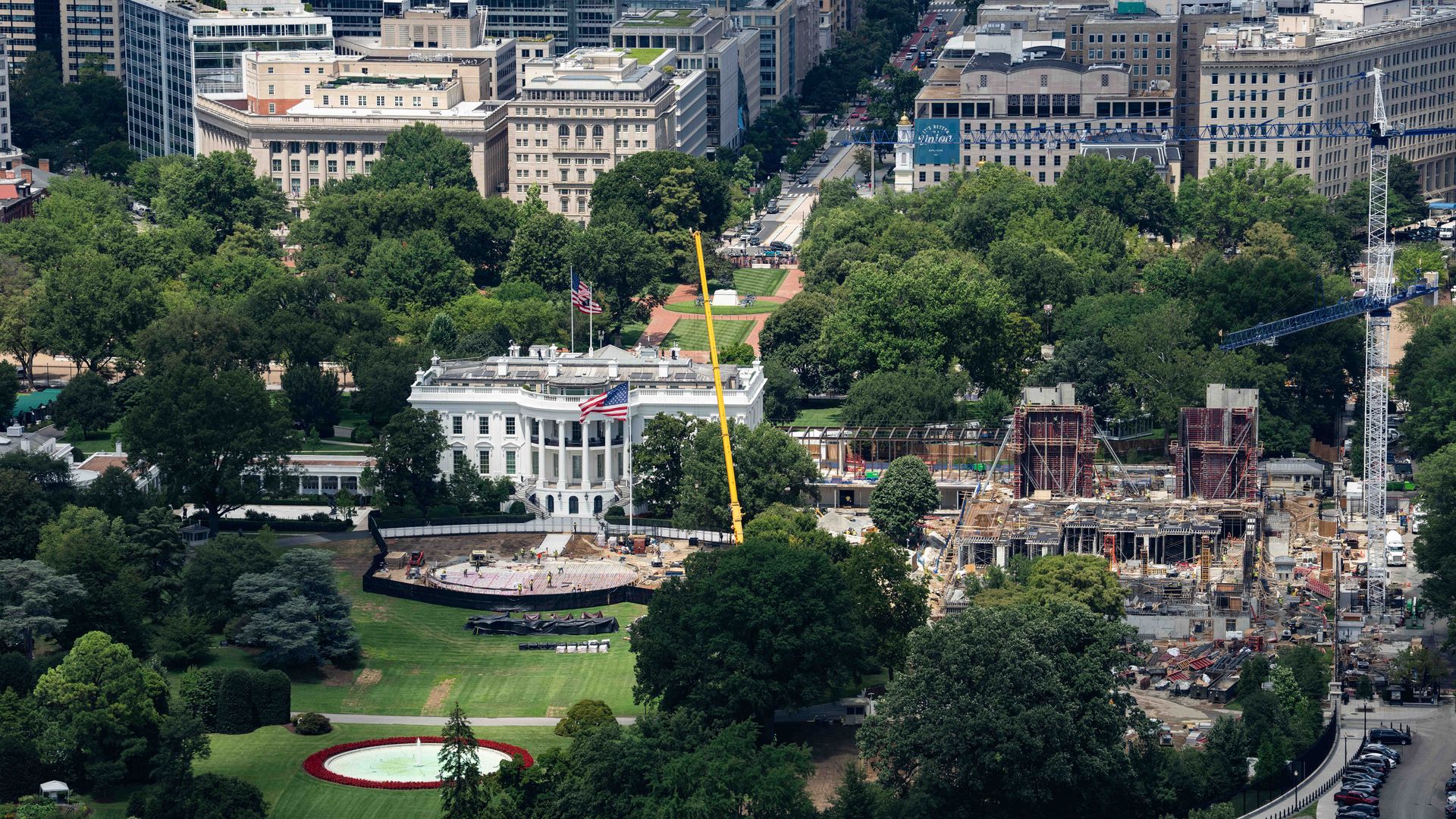A wide, overhead view of the White House helipad and new ballroom extension under construction.