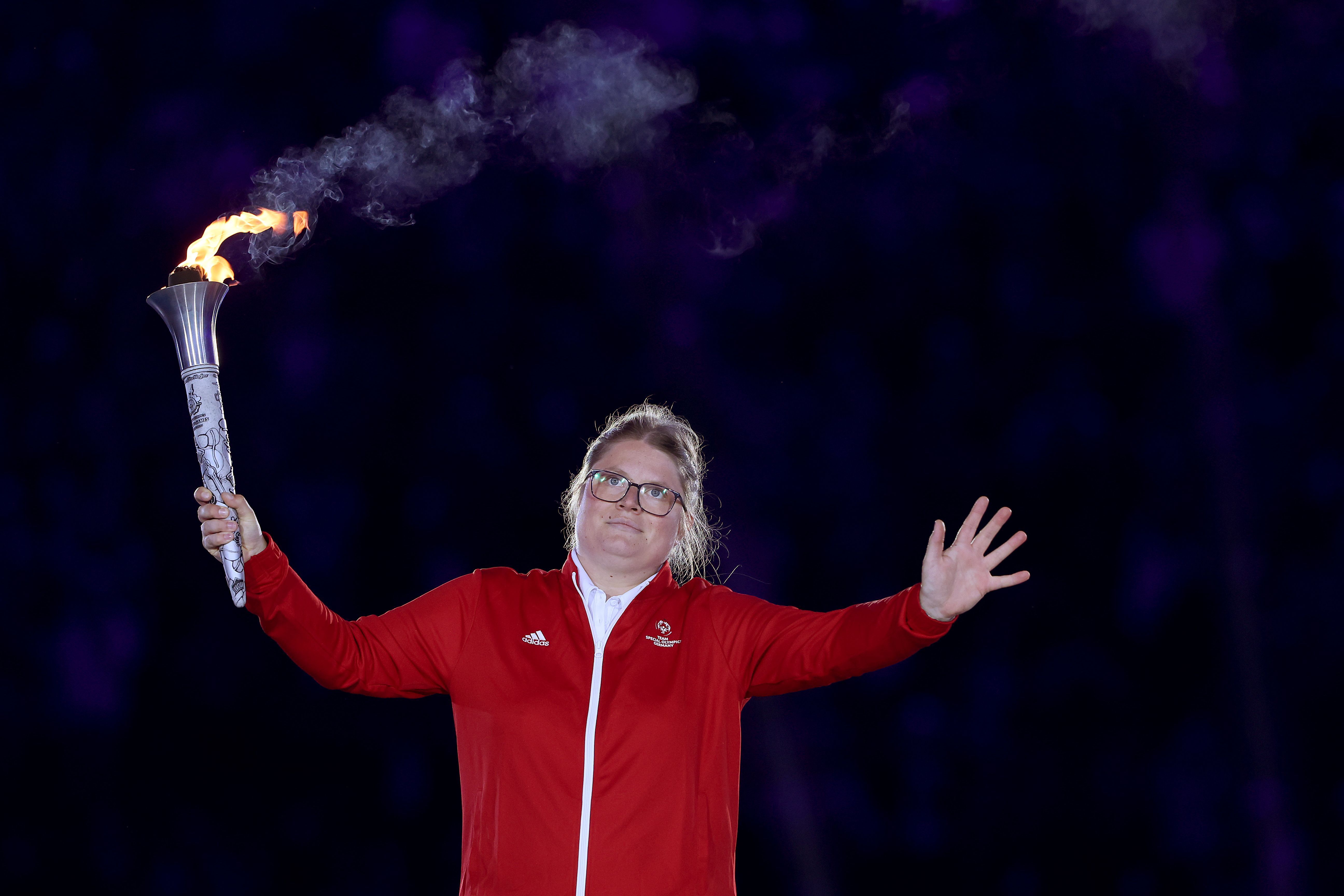 Sophie Rensmann holds the Olympic Torch during the opening ceremony of the Special Olympics World Games Berlin 2023. 