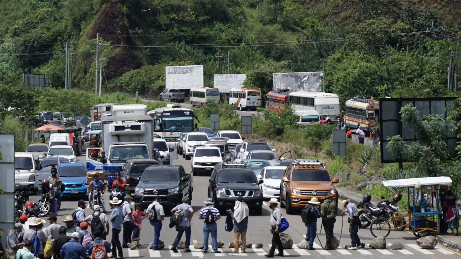 Former military men use rocks to block a road in El Boqueron, Cuilapa, Guatemala on October 13, 2021.