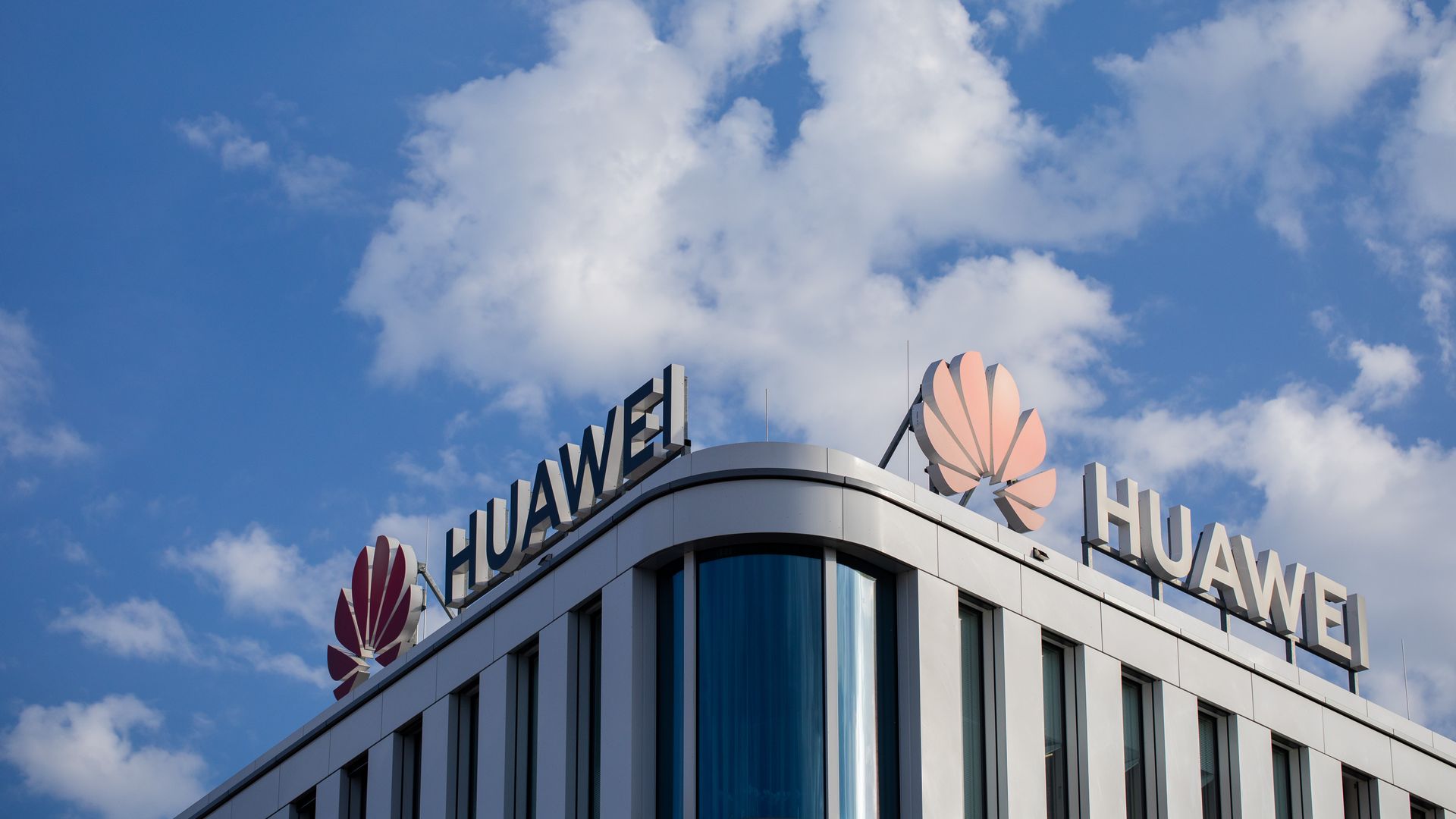 This image shows a rooftop with two Huawei logos on either side of its roof