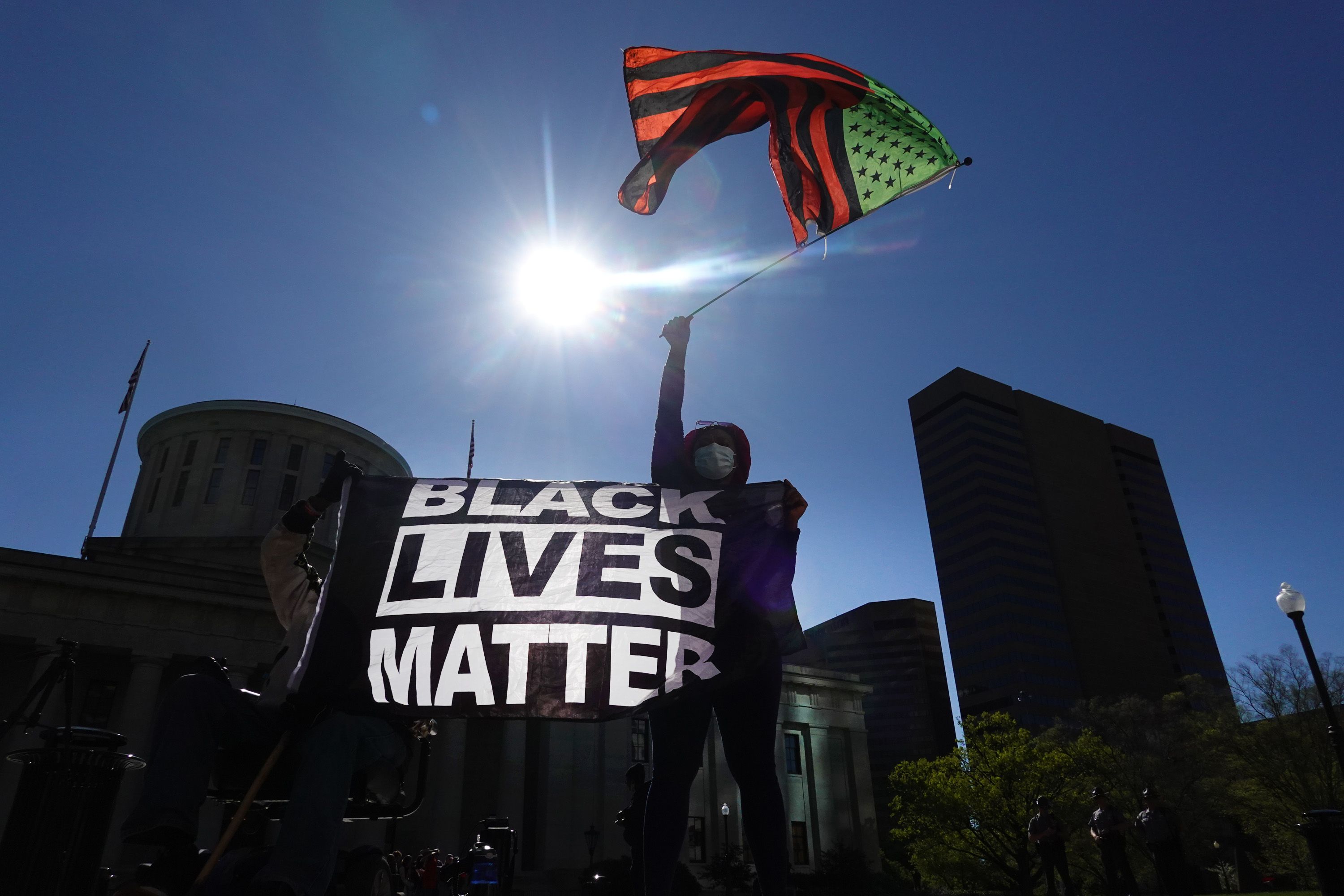 A protester holds a Black Lives Matter flag in front of the Ohio Statehouse. 