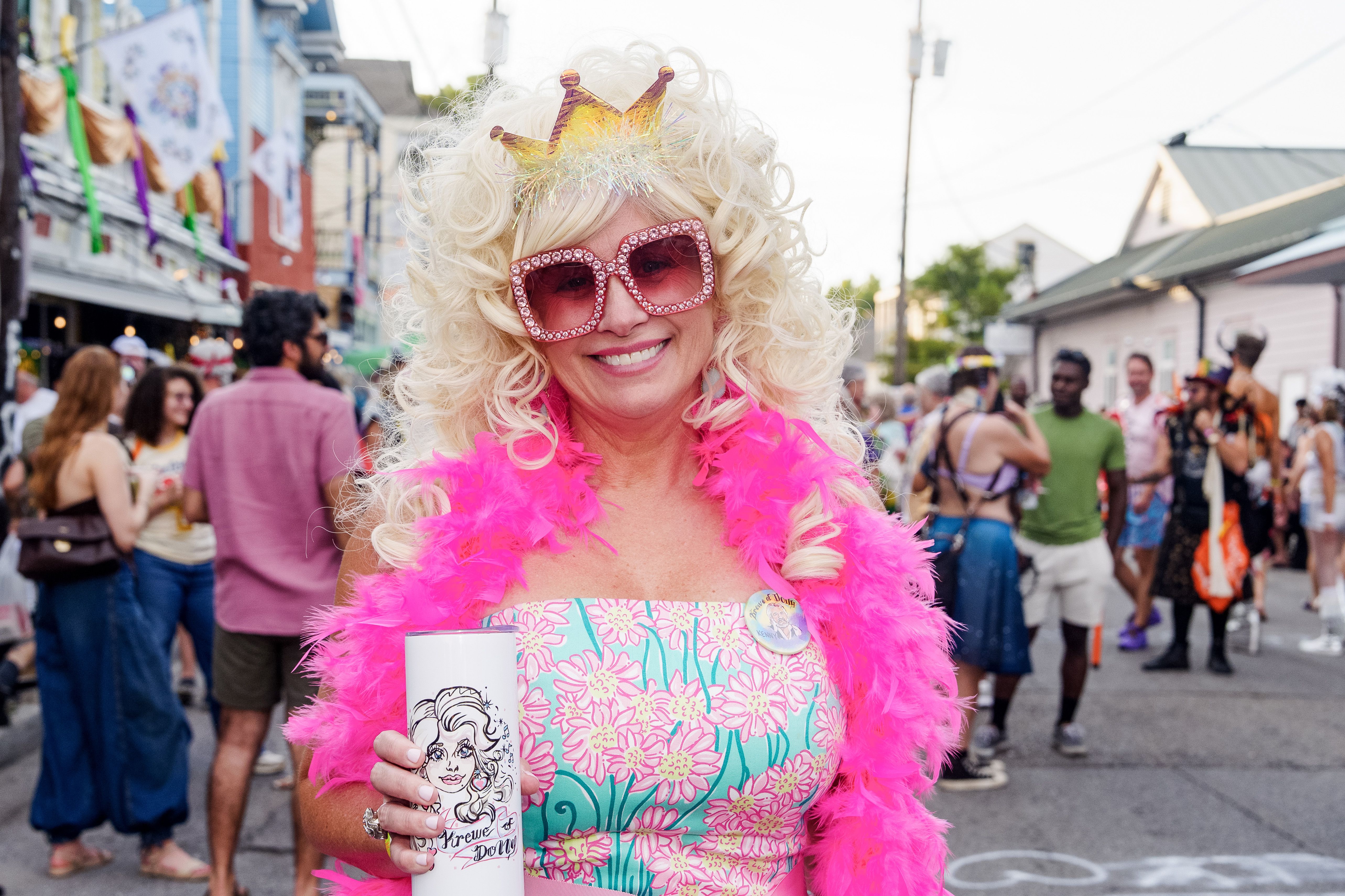Image shows a woman dressed as Dolly Paron in a New Orleans parade.