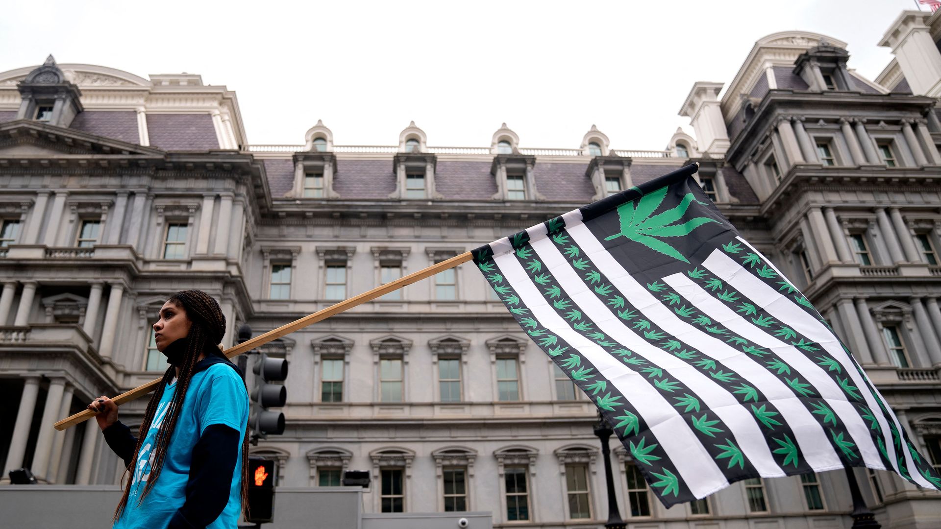 Demonstrators gather in the street near the White House in Washington, DC, on October 24, 2022, to call on US President Joe Biden to take action on cannabis clemency ahead of the midterm election. 