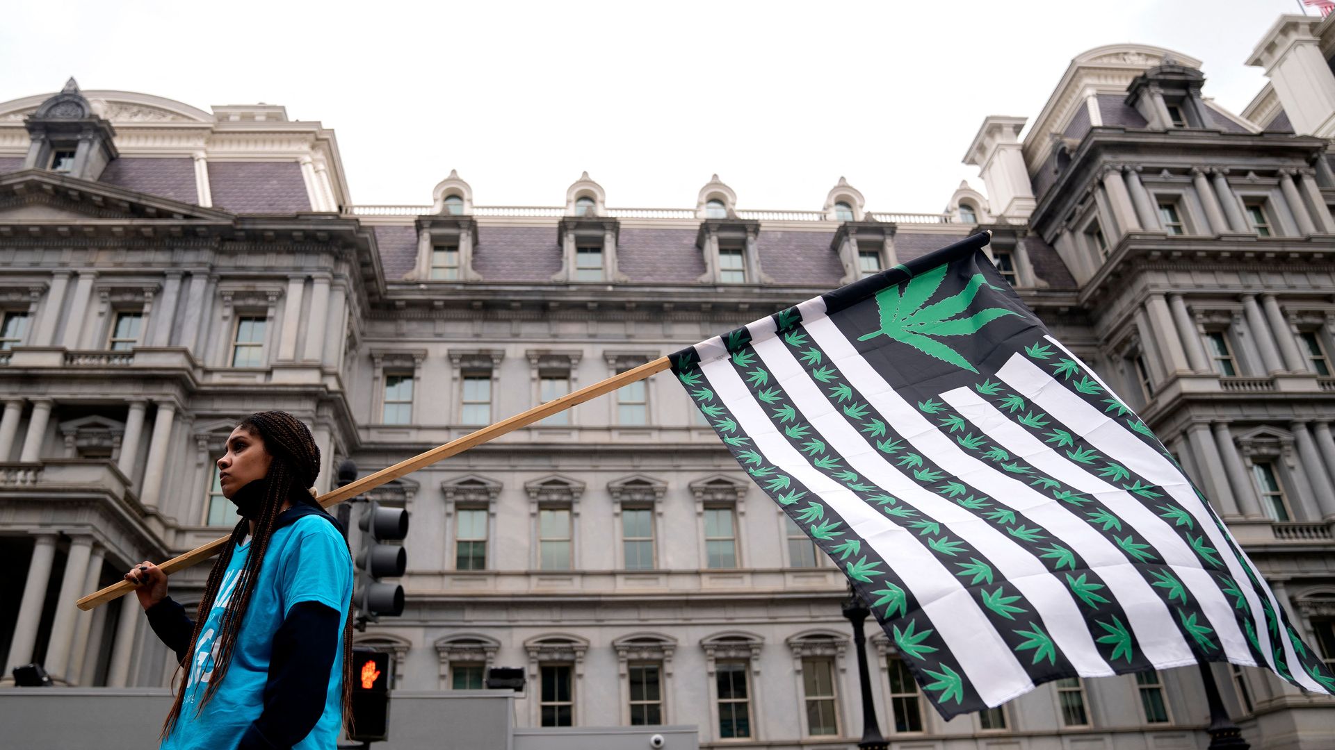 Demonstrators gather in the street near the White House in Washington, DC, on October 24, 2022, to call on US President Joe Biden to take action on cannabis clemency ahead of the midterm election.