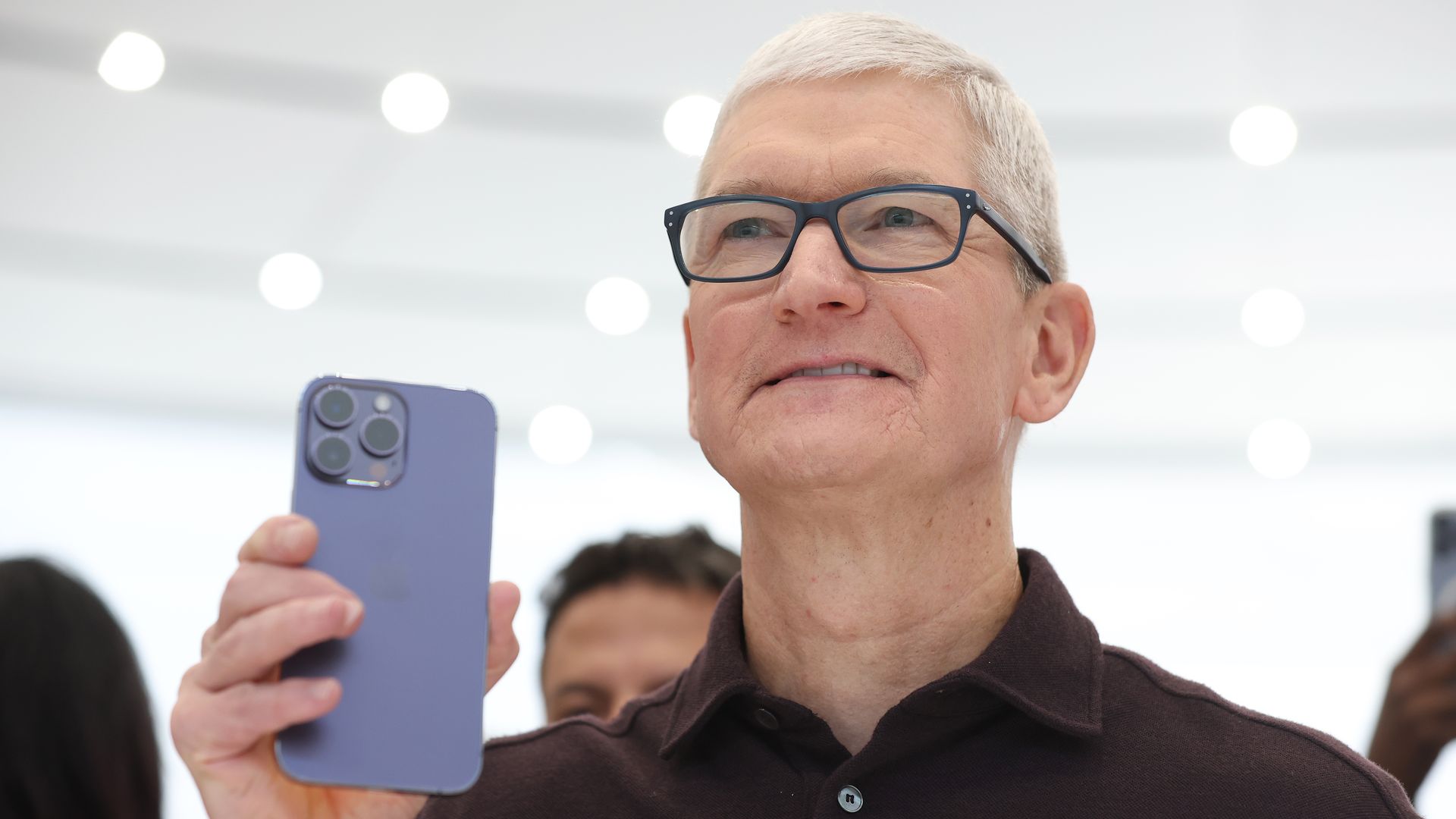 Tim Cook, holding up an iPhone 14 Pro at the product's launch. 