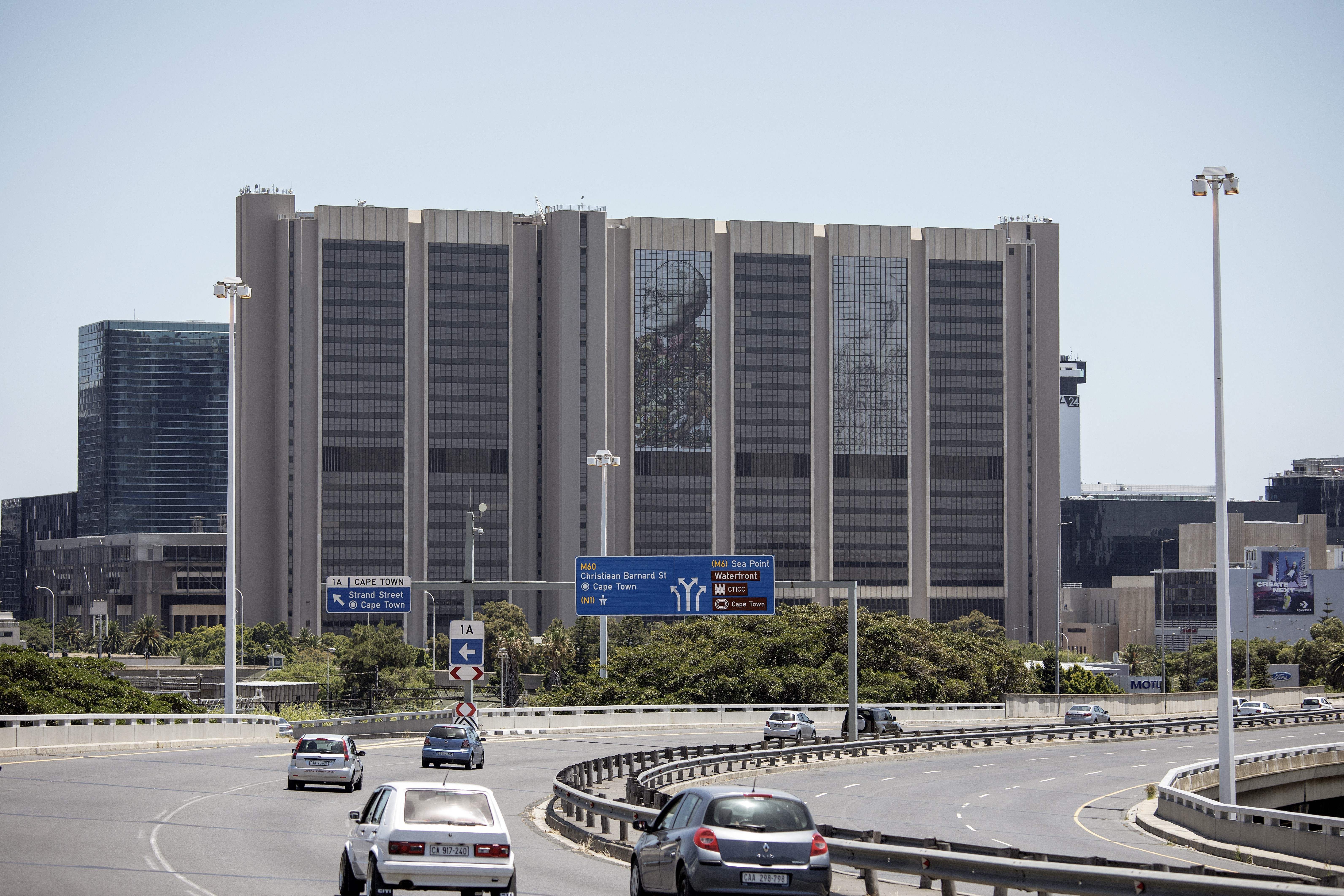An image depicting the late South African Nobel Peace Price Archbishop Desmond Tutu is seen on December 26, 2021 on the facade of the Cape Town City Centre on the wake of his death in Cape Town. 