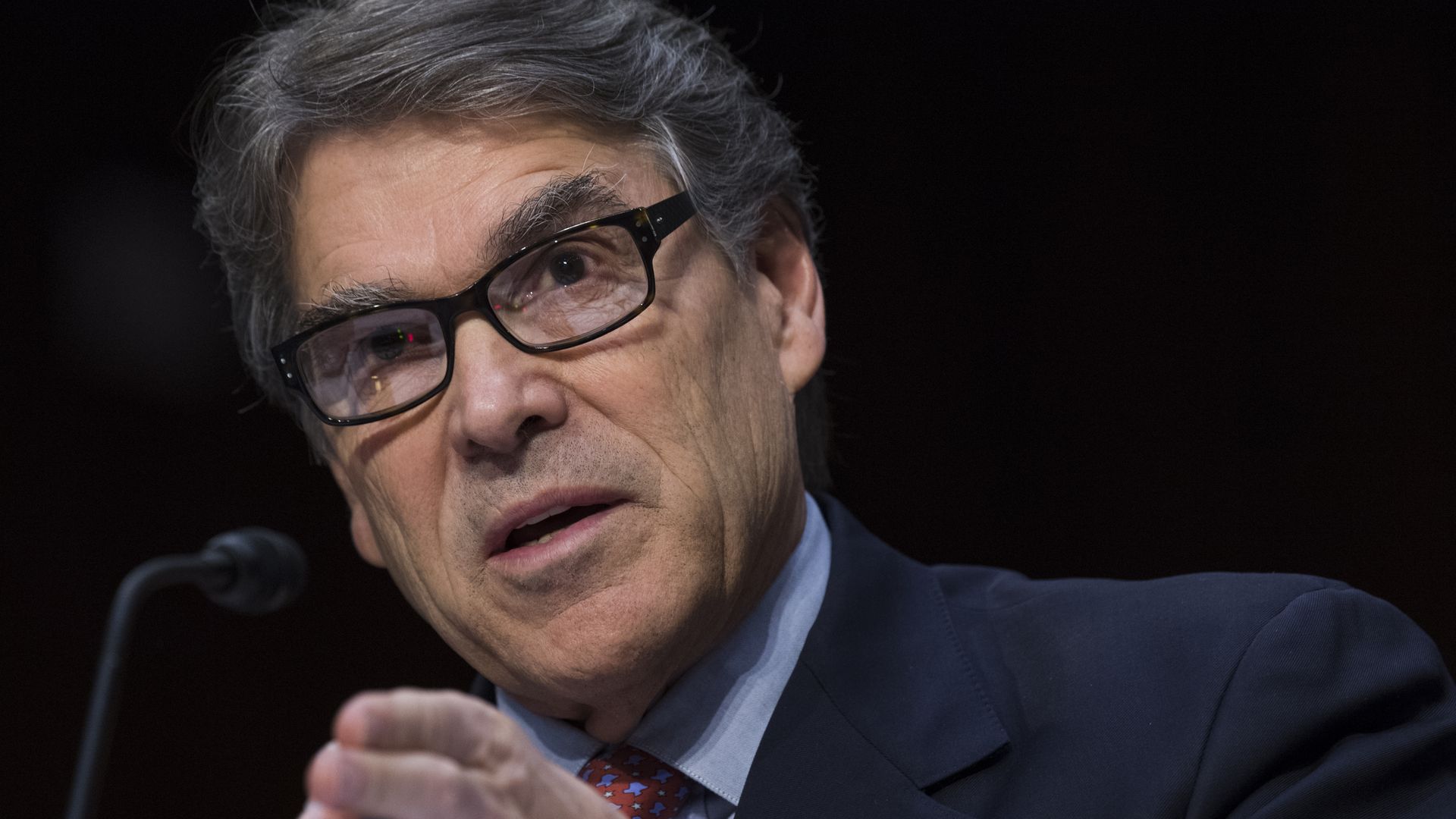 Rick Perry gestures to the crowd while speaking