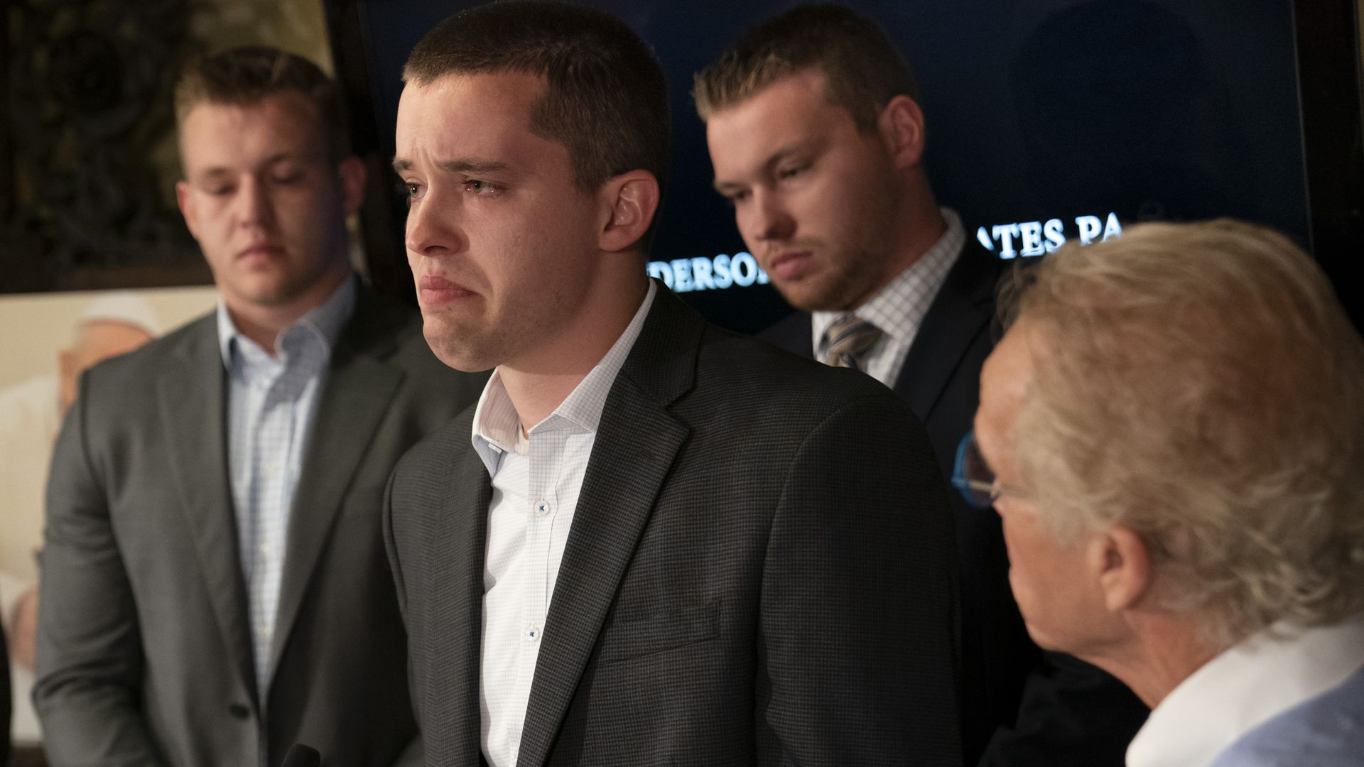 Luke Hoffman, left, Ben Hoffman and Stephen Hoffman with their attorney Jeff Anderson.