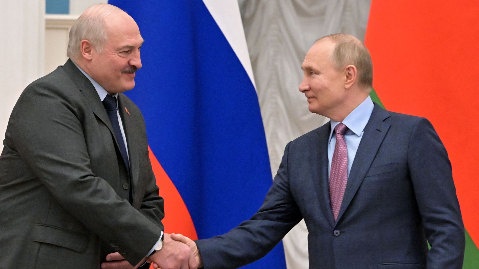 Russian President Vladimir Putin shaking hands with Belarusian President Alexander Lukashenko in Moscow in February 2022.