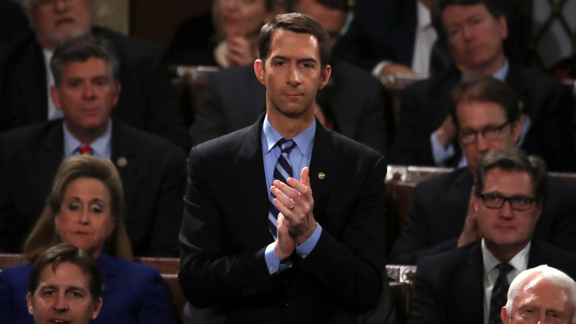 Tom Cotton standing and clapping.