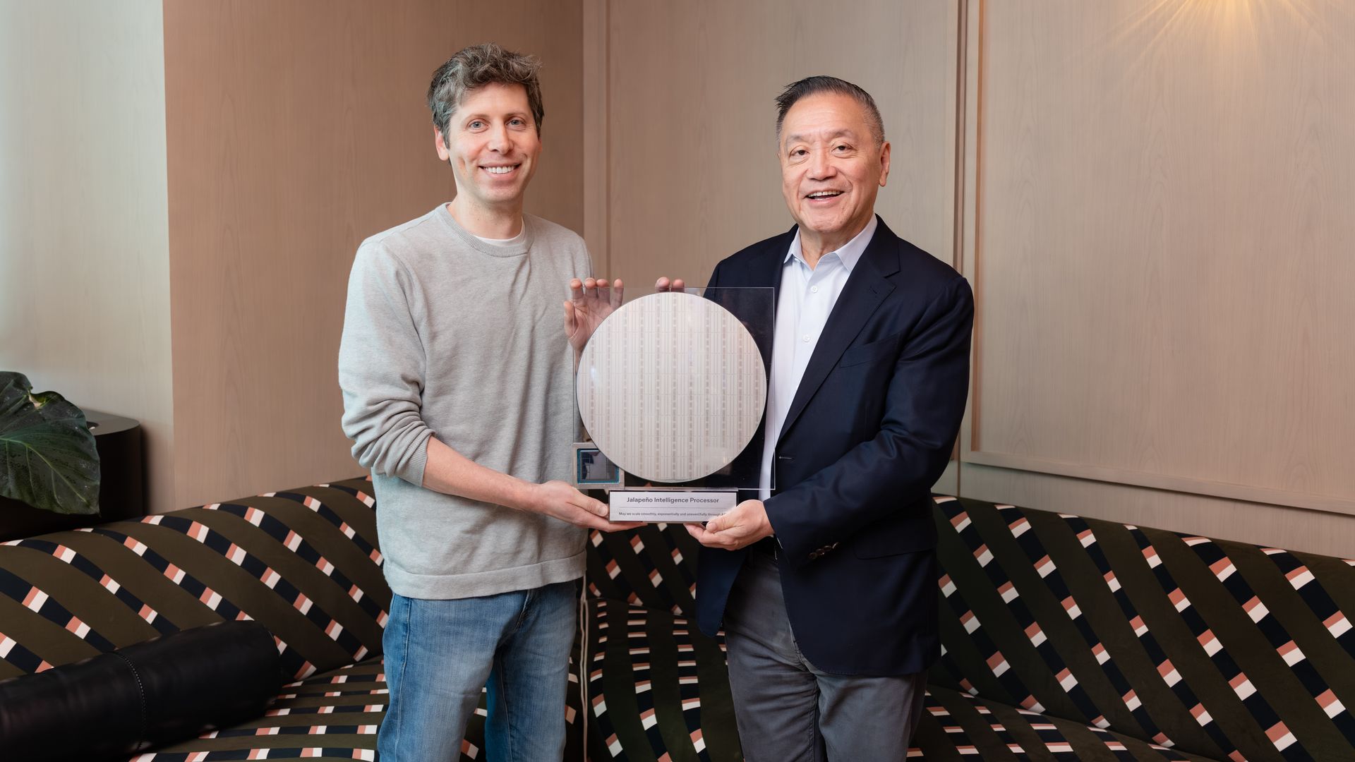 Broadcom CEO Hock Tan delivers a chip wafer to OpenAI CEO Sam Altman